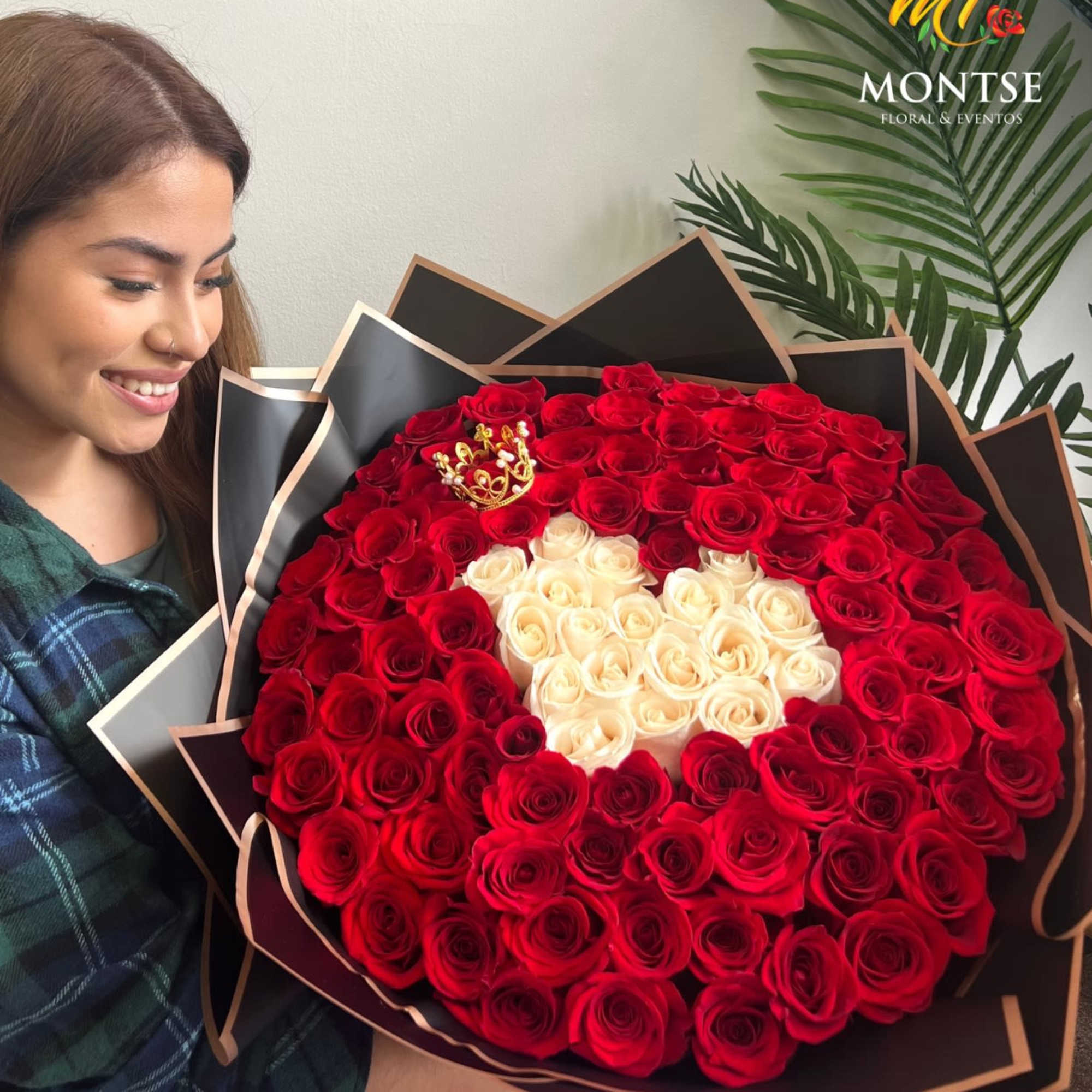 Large bouquet of red and white roses with a small crown accent