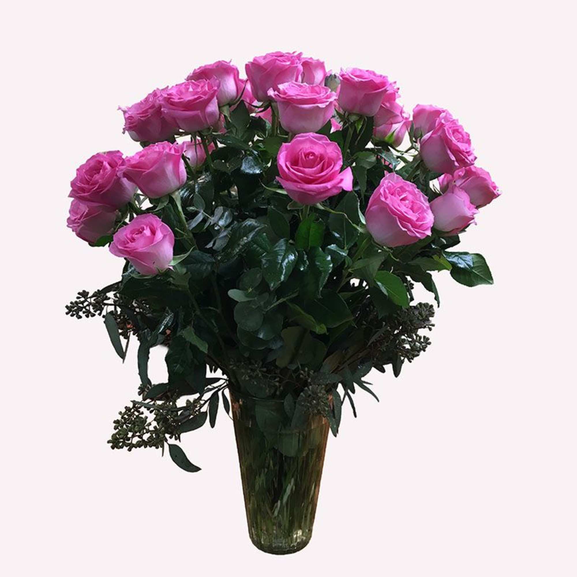 Pink roses arranged in a tall glass vase