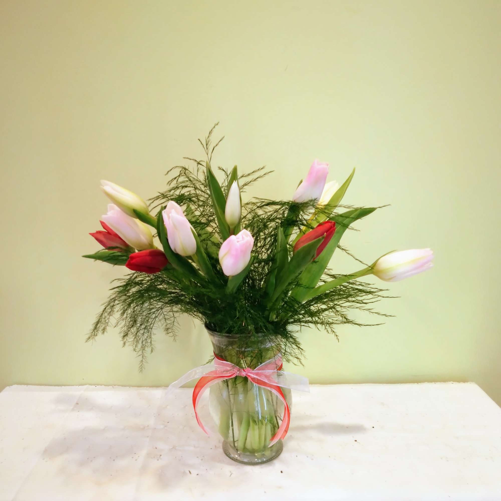 'Tulips Tulips Tulips' features a clear molded glass vase, foliage and you