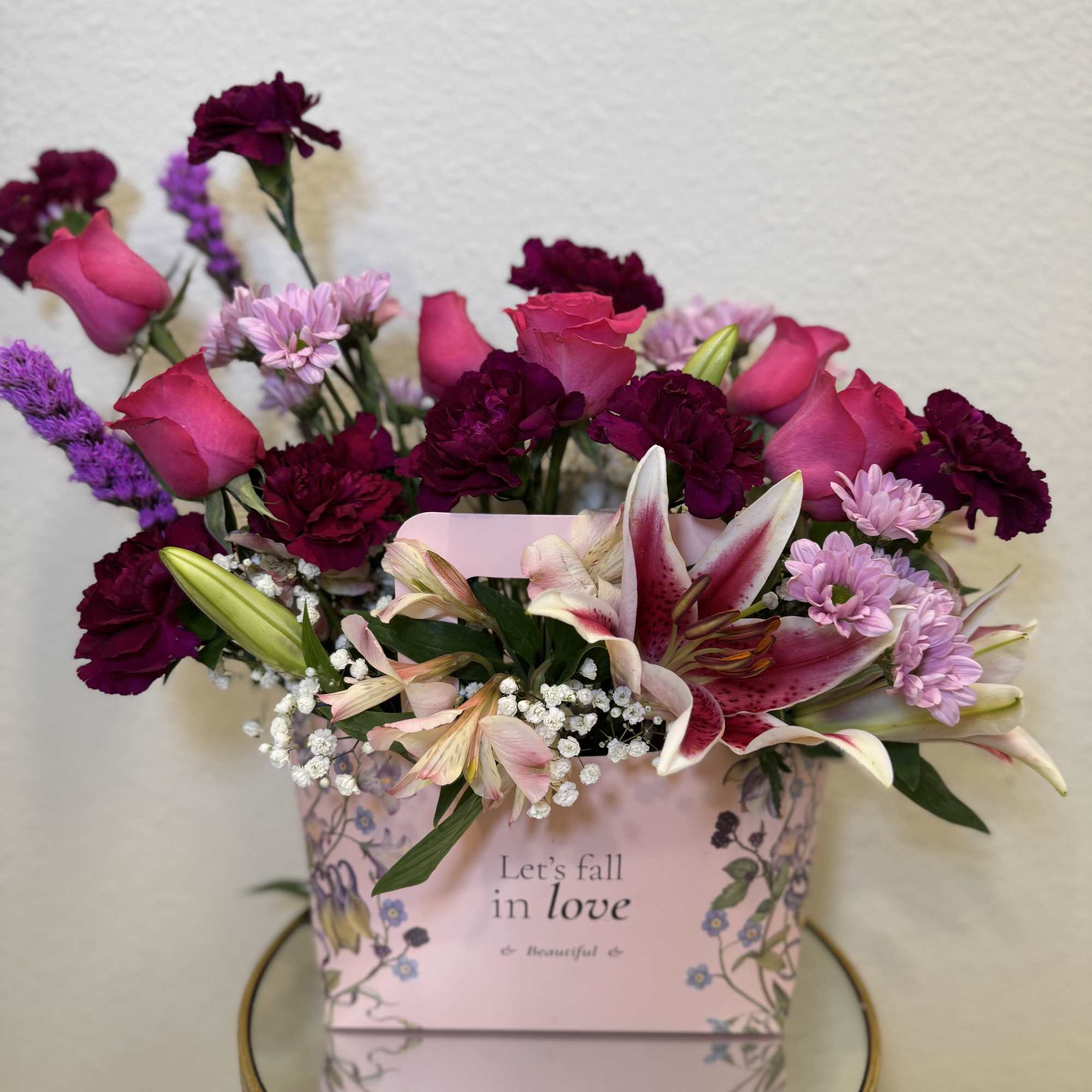 Pink and burgundy mixed bouquet in a decorative gift box