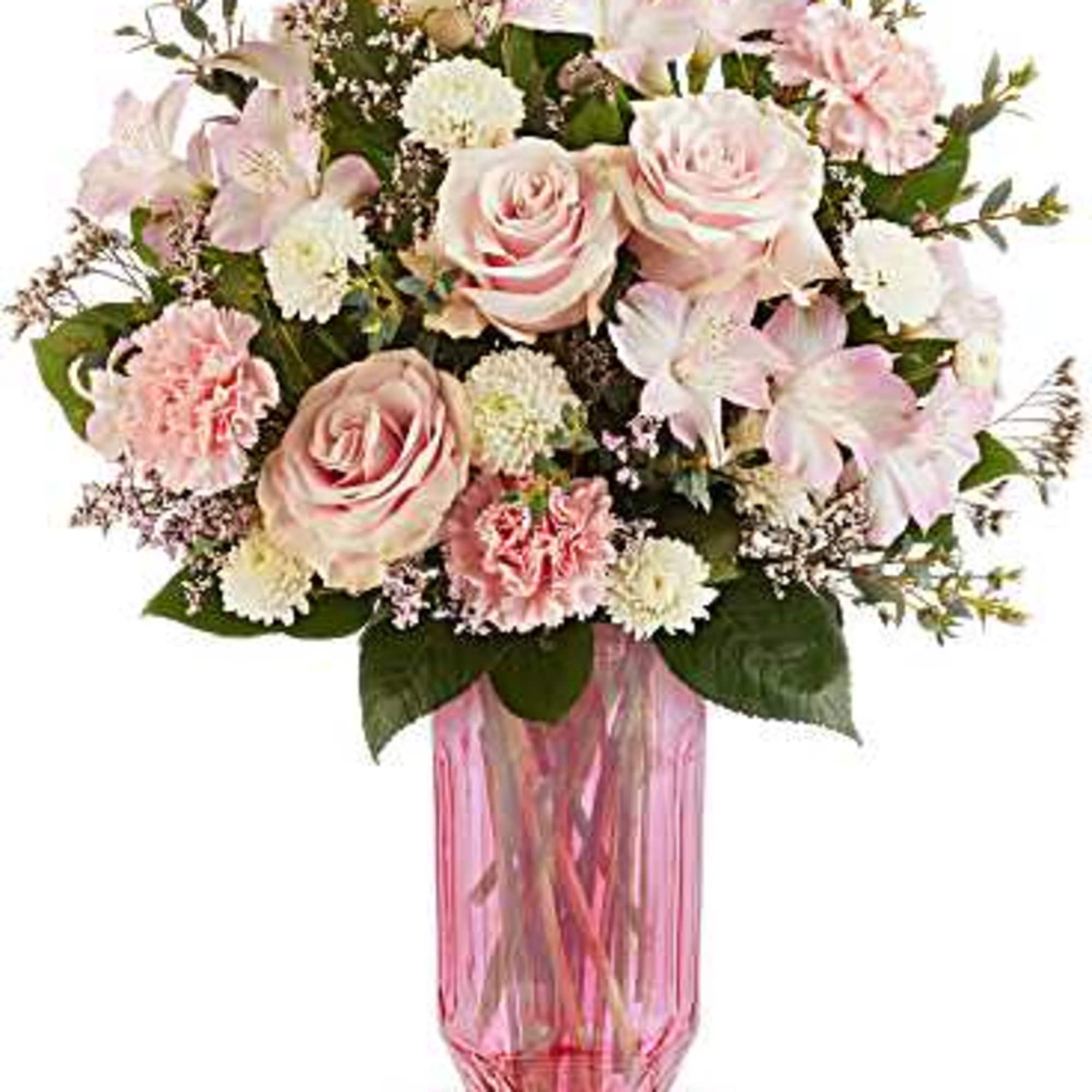 Pink and white bouquet in a tall pink glass vase