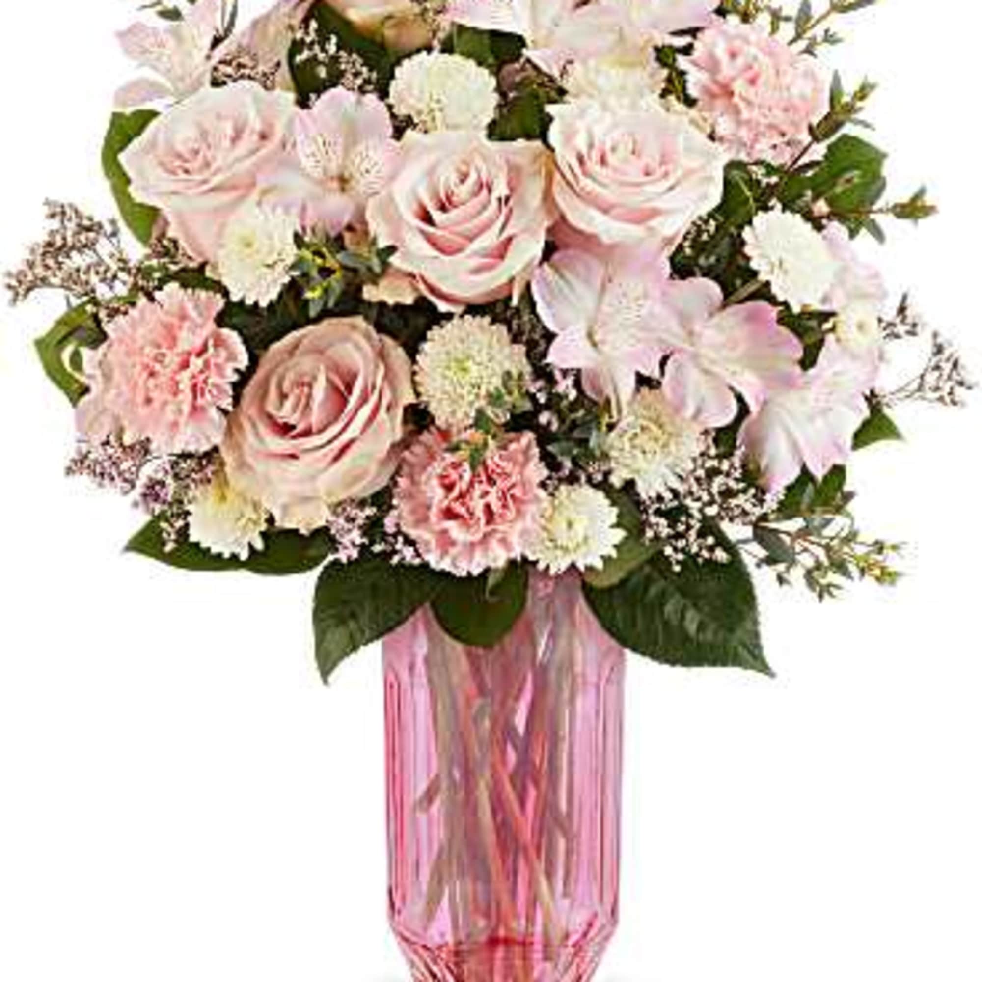 Pink roses and carnations in a pink glass vase