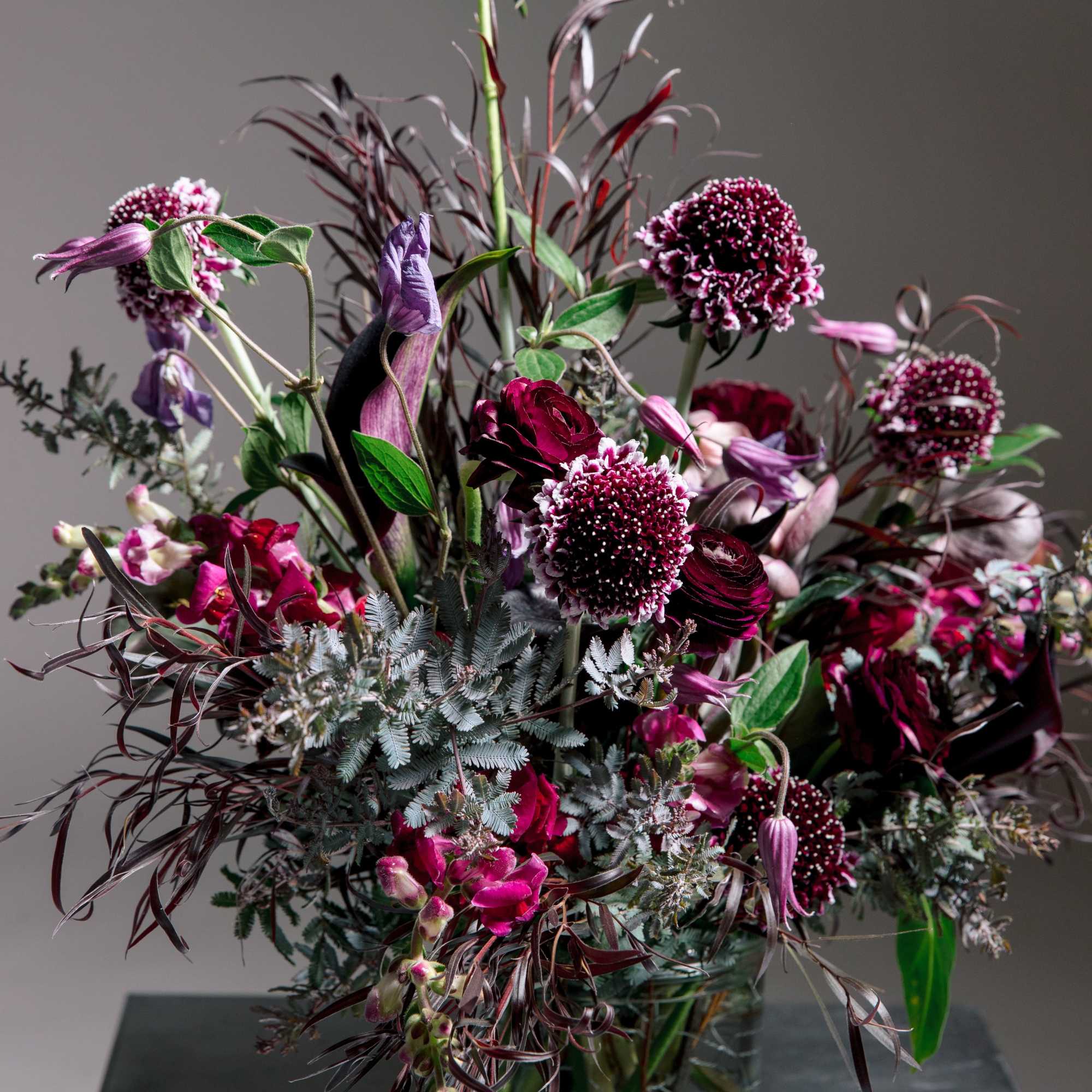 ALL DESIGNS IN PHOTOS ARE DELUXE +
Moody, romantic, and undeniably modern-this tall