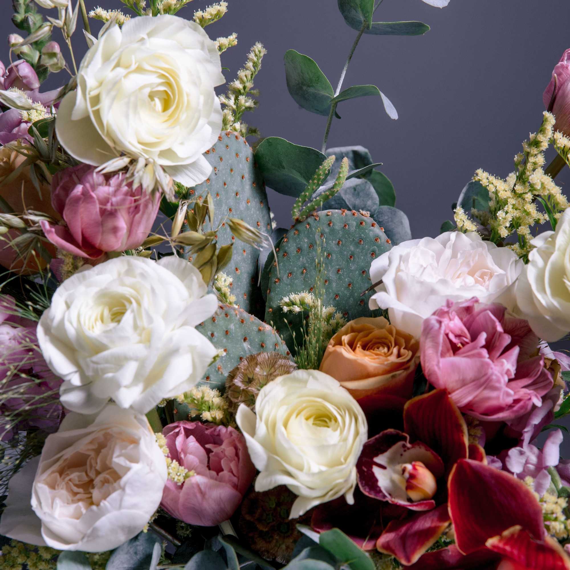 A sculptural, garden-style flower arrangement that pairs classic roses and tulips with
