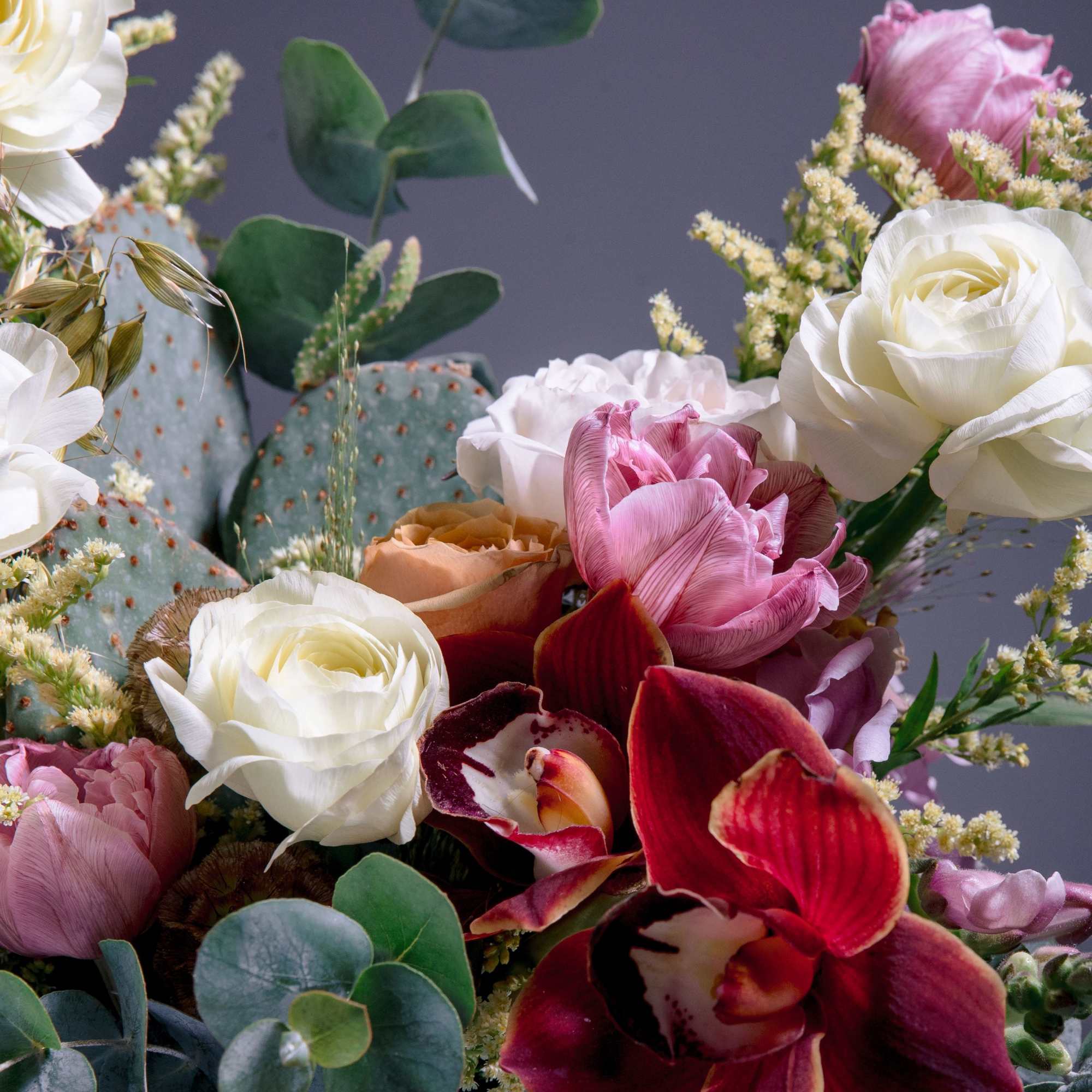 A sculptural, garden-style flower arrangement that pairs classic roses and tulips with