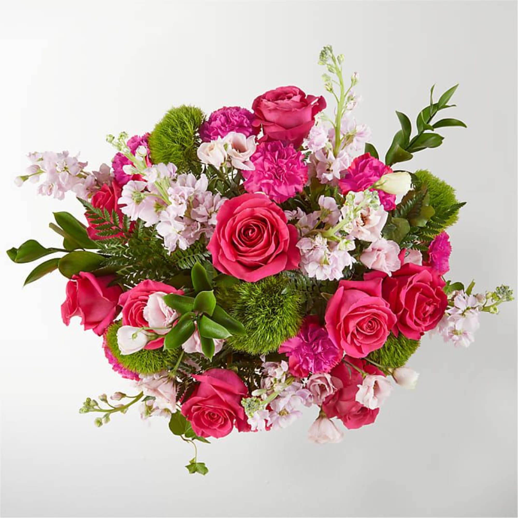 Pink rose bouquet with pale blossoms and green accents