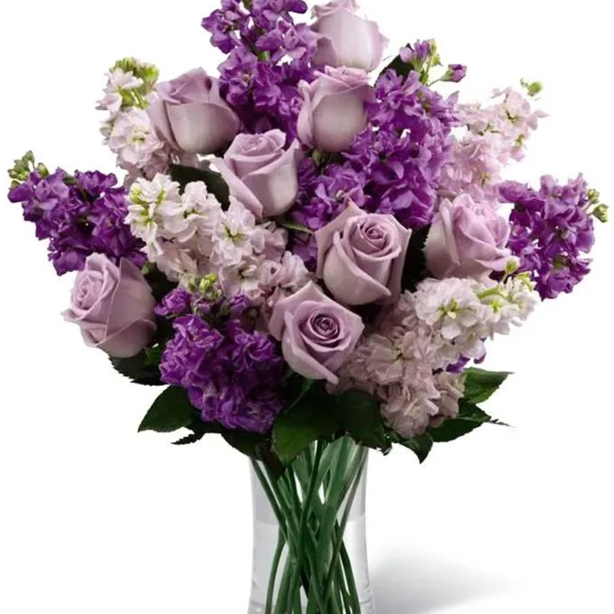 Lavender roses and purple flowers in a clear glass vase