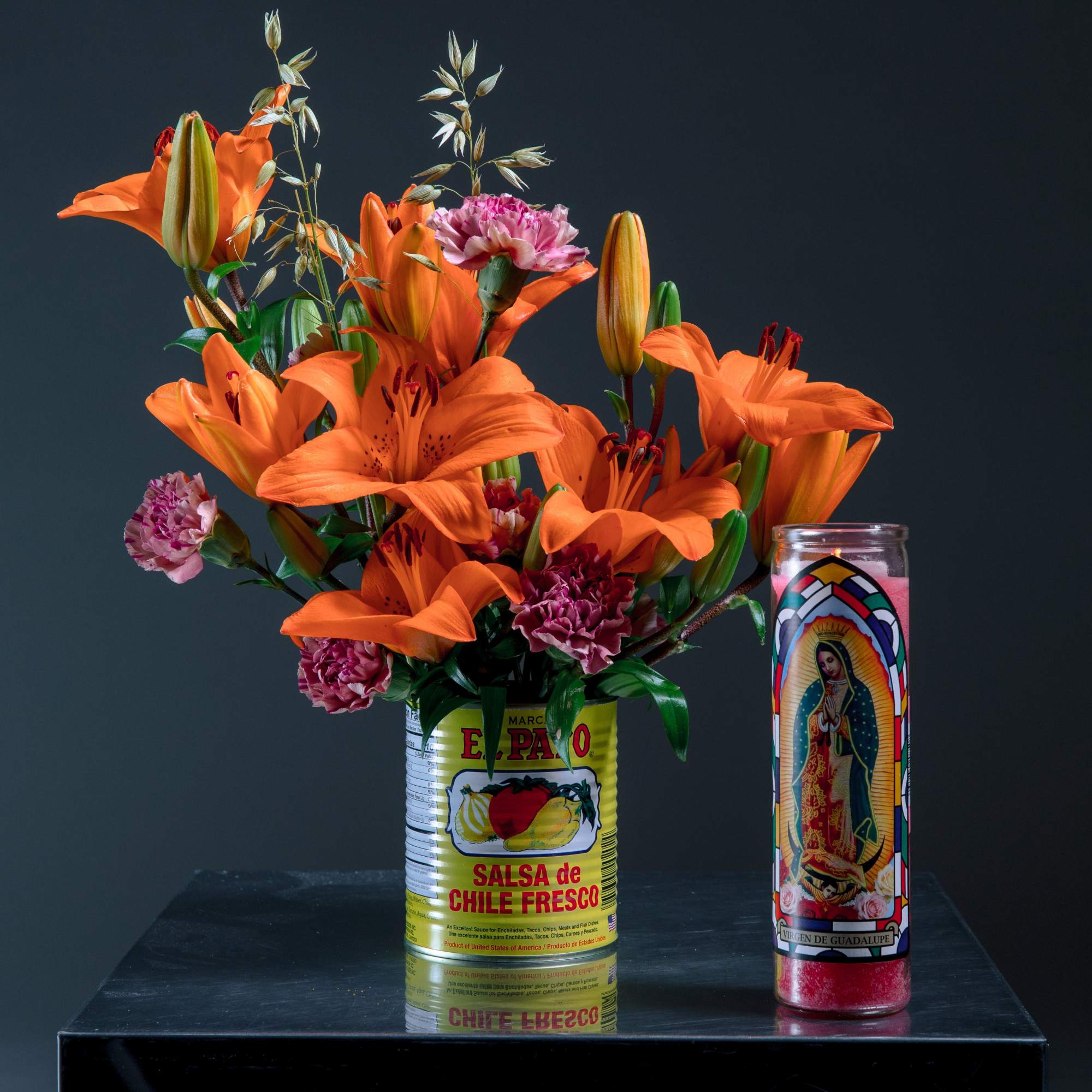 Bold lilies and carnations designed into a Pato sauce can, paired with