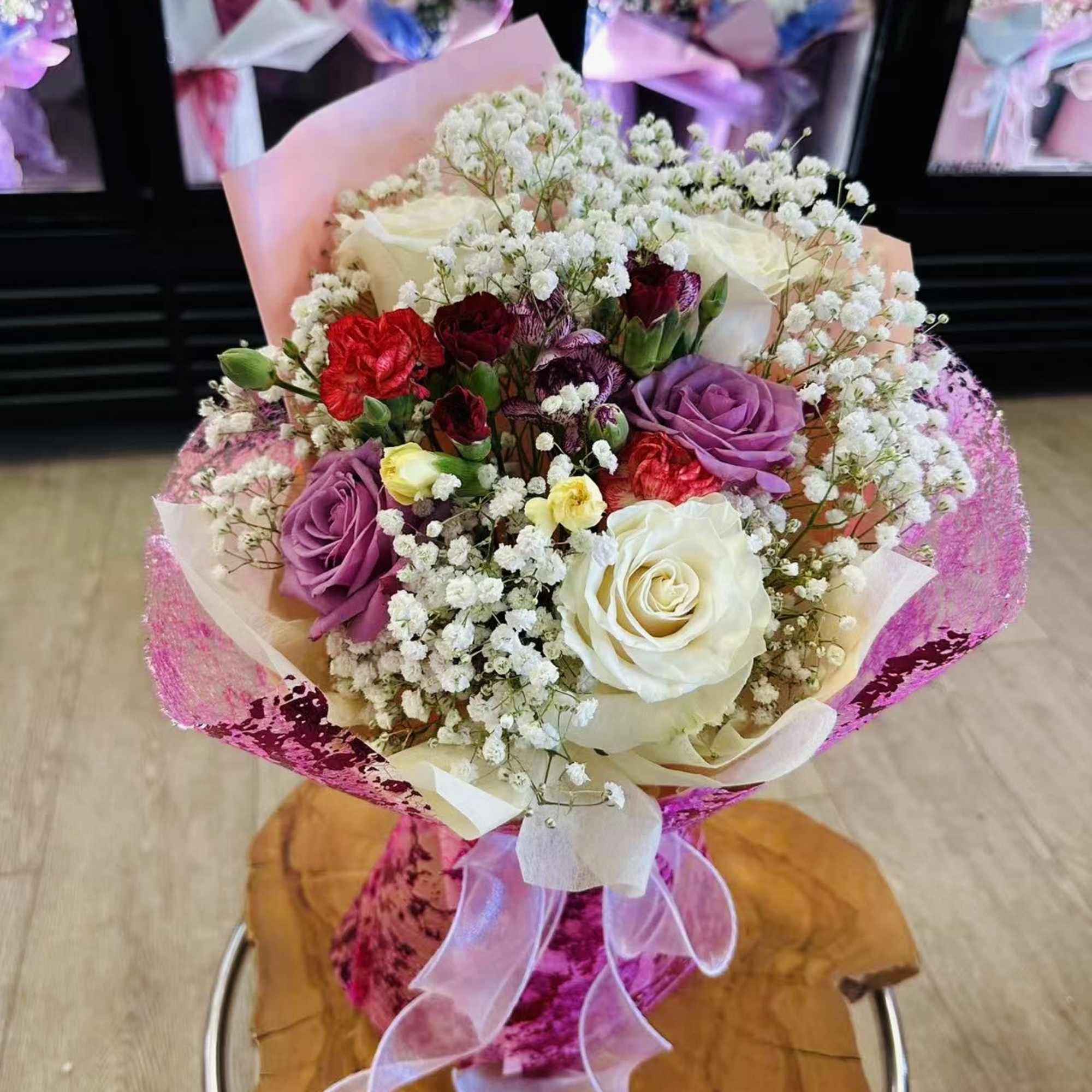 Bouquet is small size with 5 mixed roses and filled flowers 