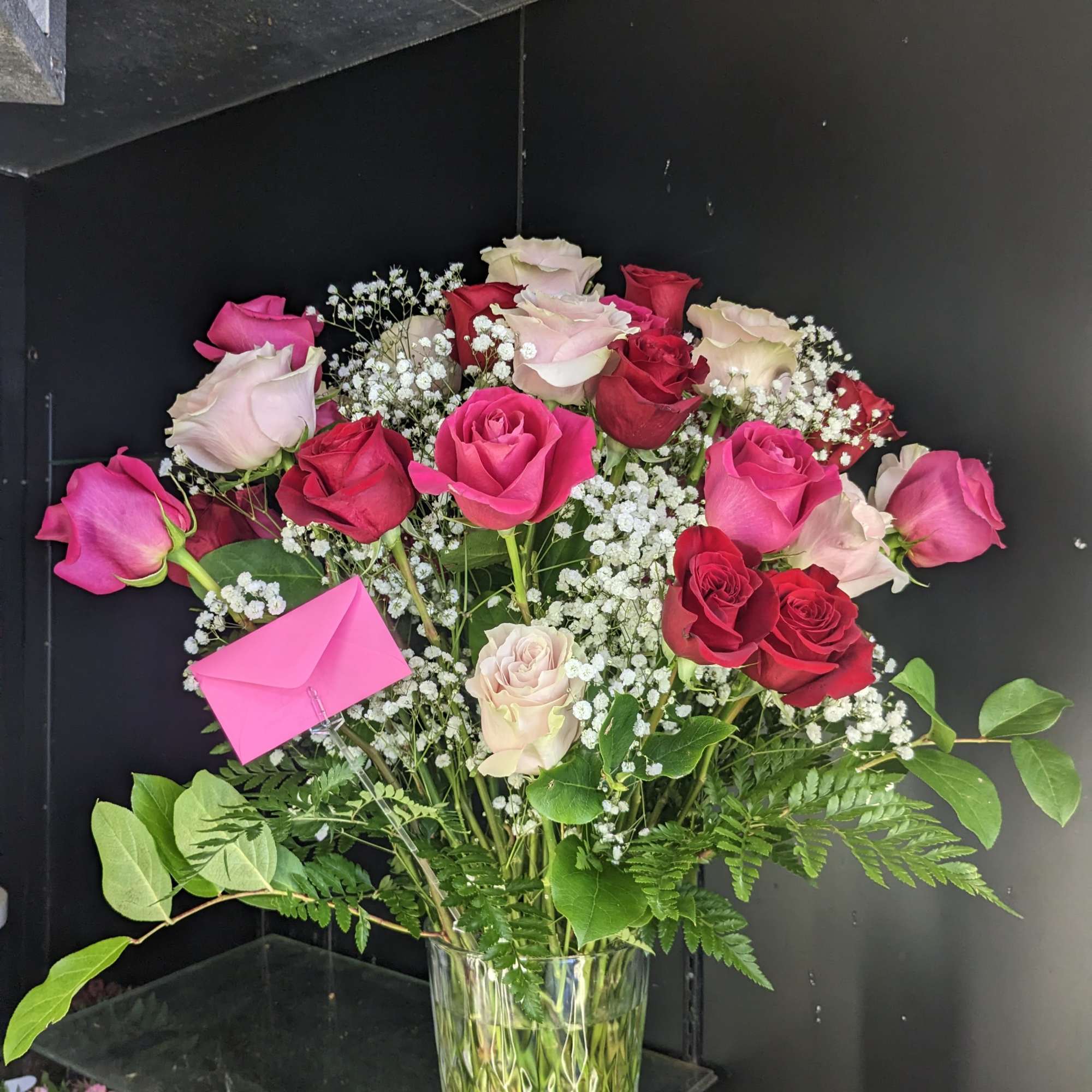 Bouquet of pink and red roses in a clear glass vase