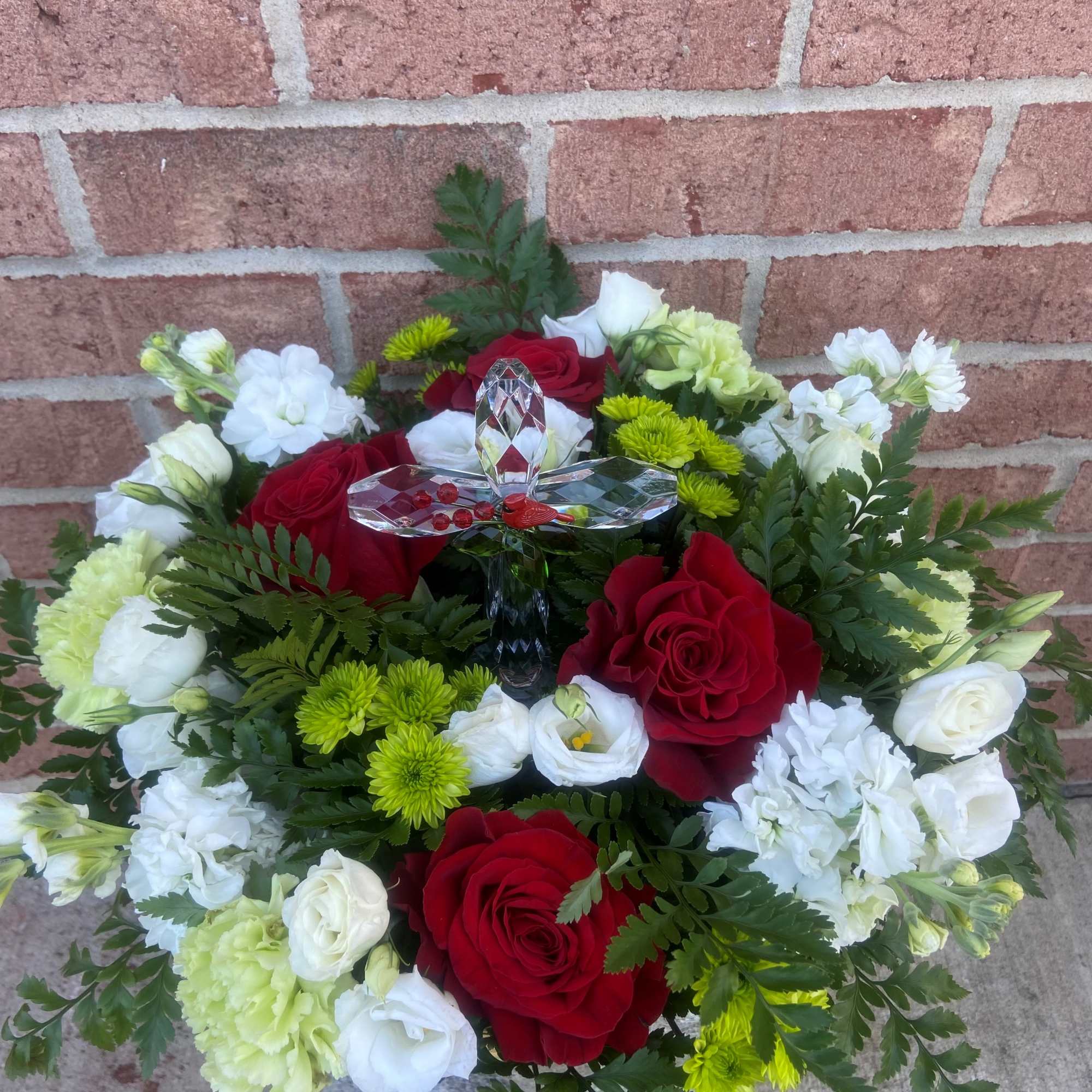 Bouquet of red and white flowers with a crystal butterfly ornament