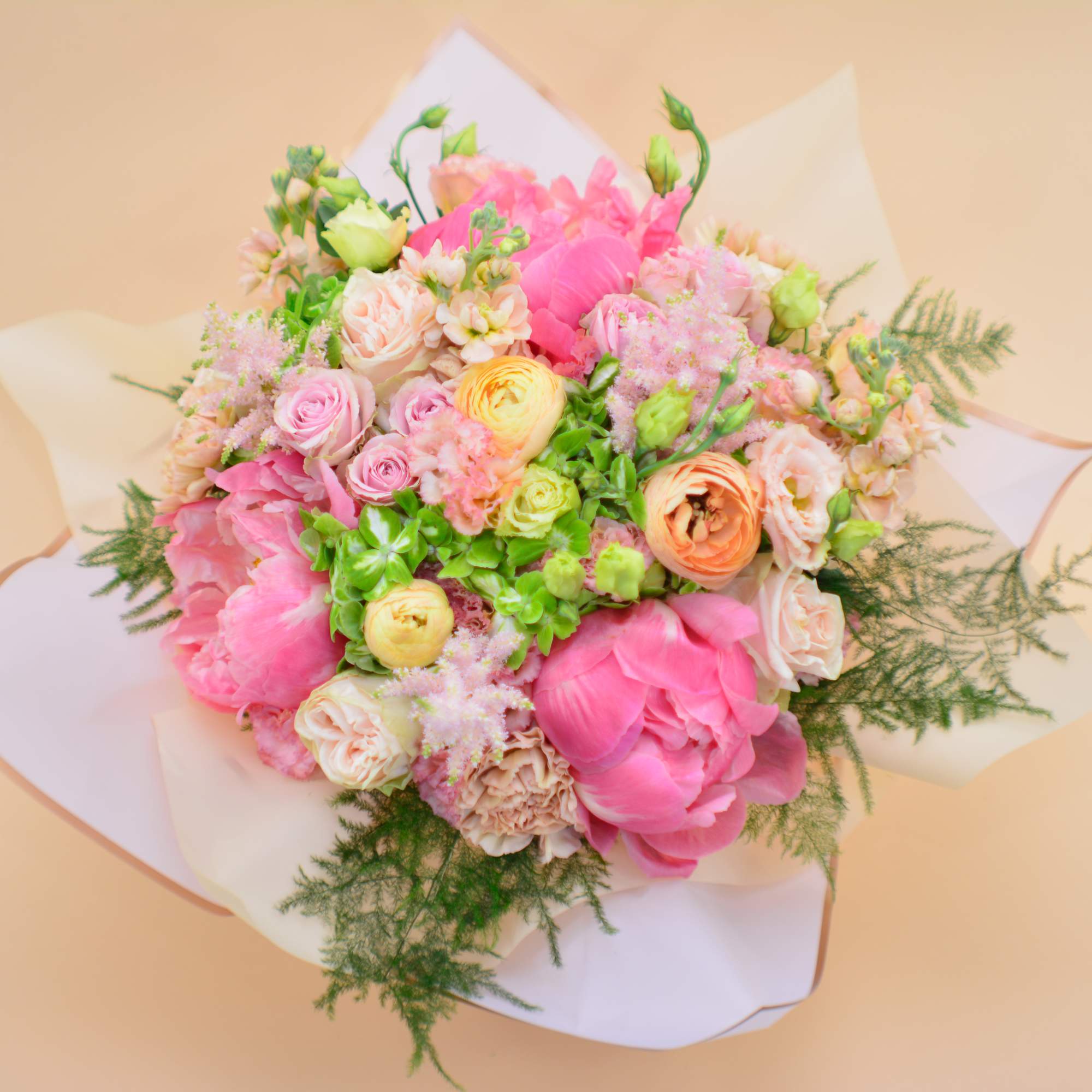 A sweet combination of colors, with coral peonies, pink roses, peach ranunculus