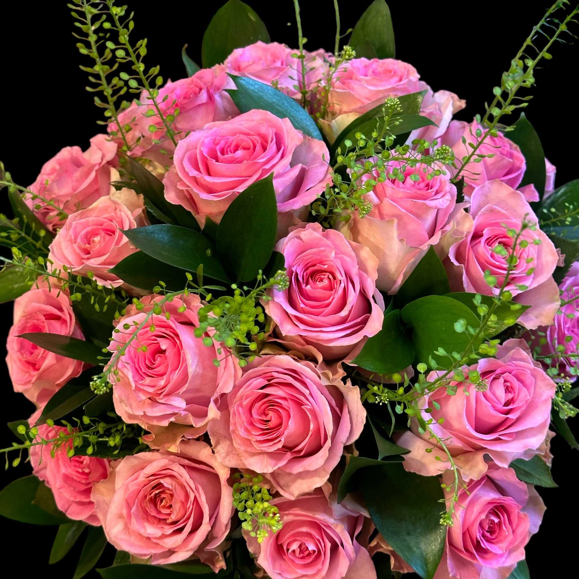 Bouquet of pink roses with dark green foliage