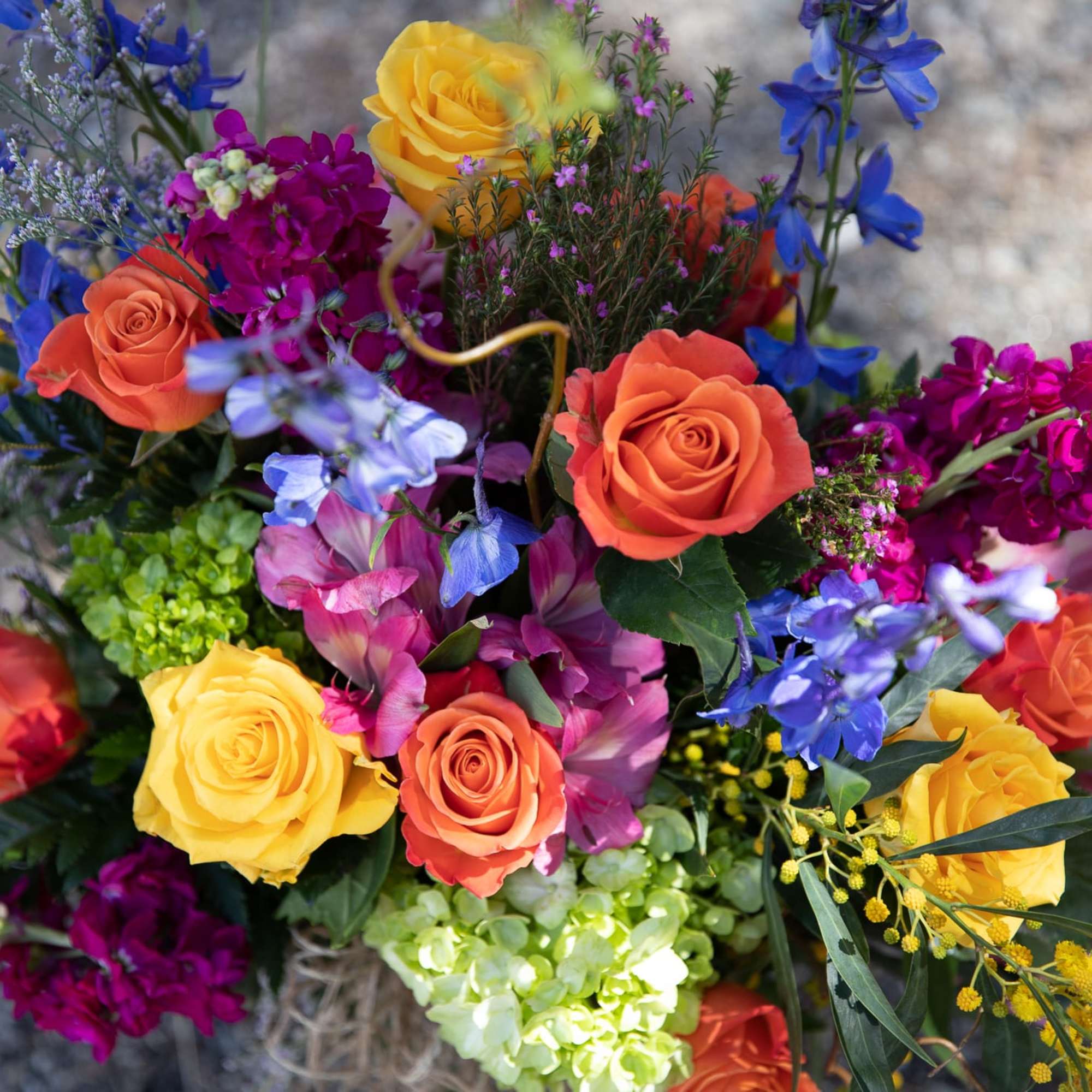 Colorful bouquet with roses, blue flowers, and mixed blooms