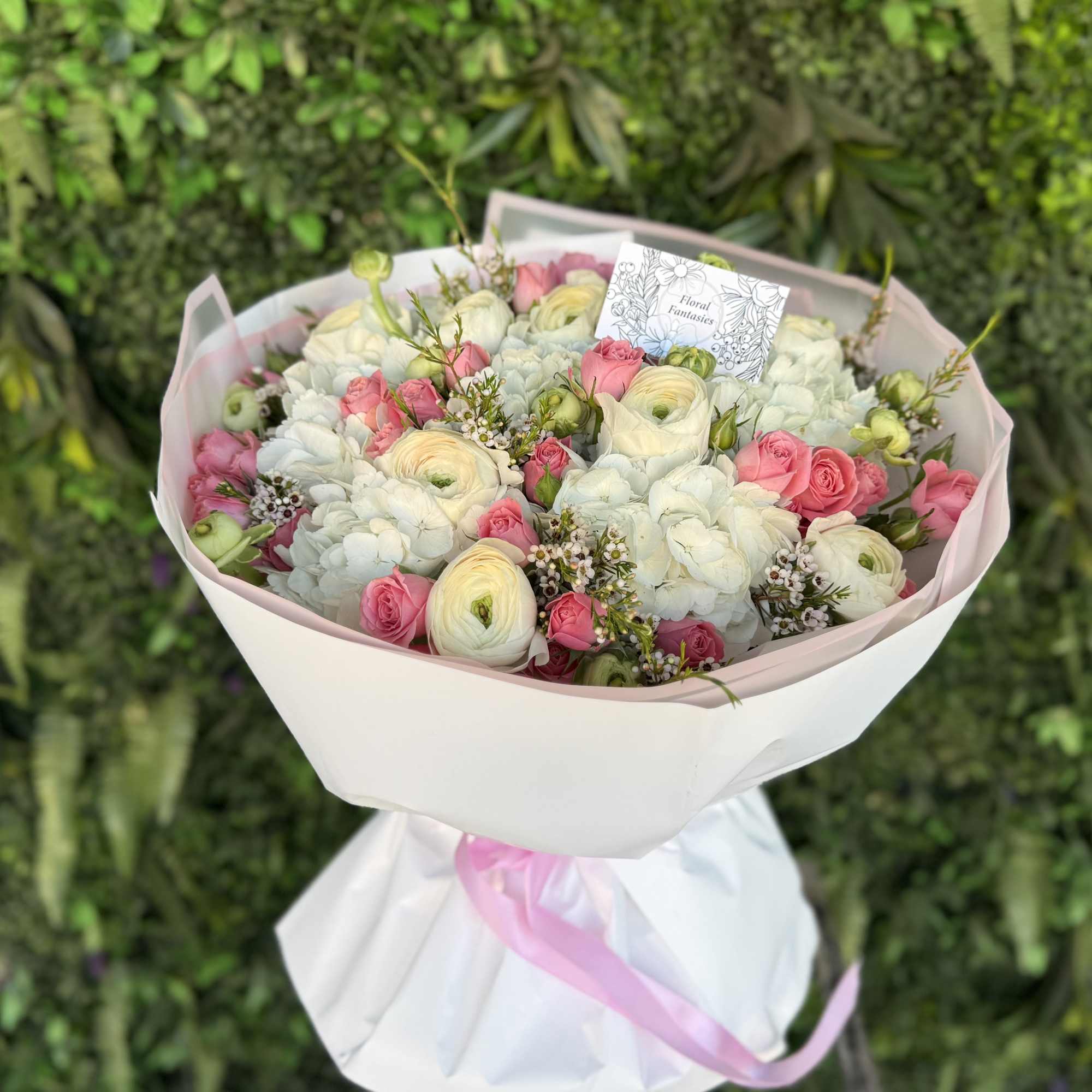 An elegant floral arrangement featuring a blend of pure white and vibrant