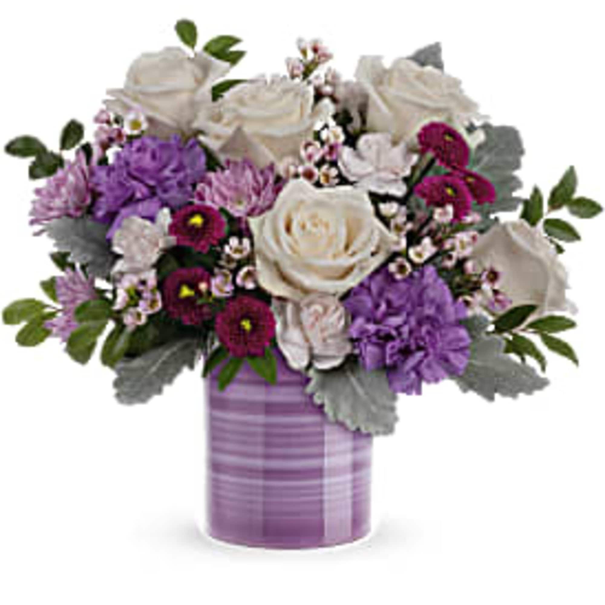 Lavender and white flower arrangement with roses and carnations in a striped lavender cylinder vase.
