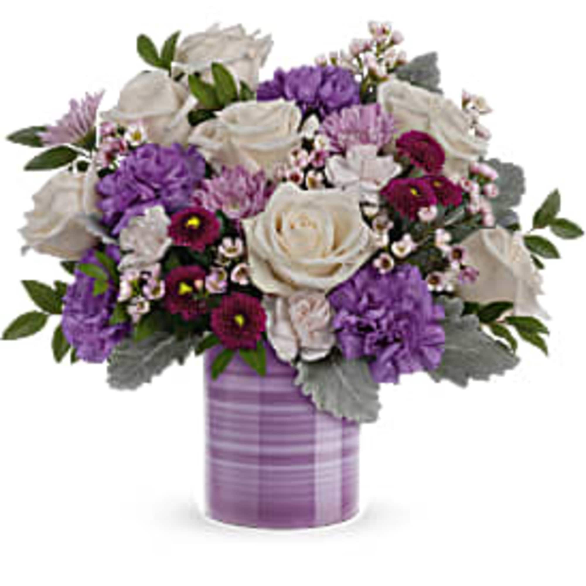 Arrangement of white roses and purple flowers in a lavender striped cylinder vase