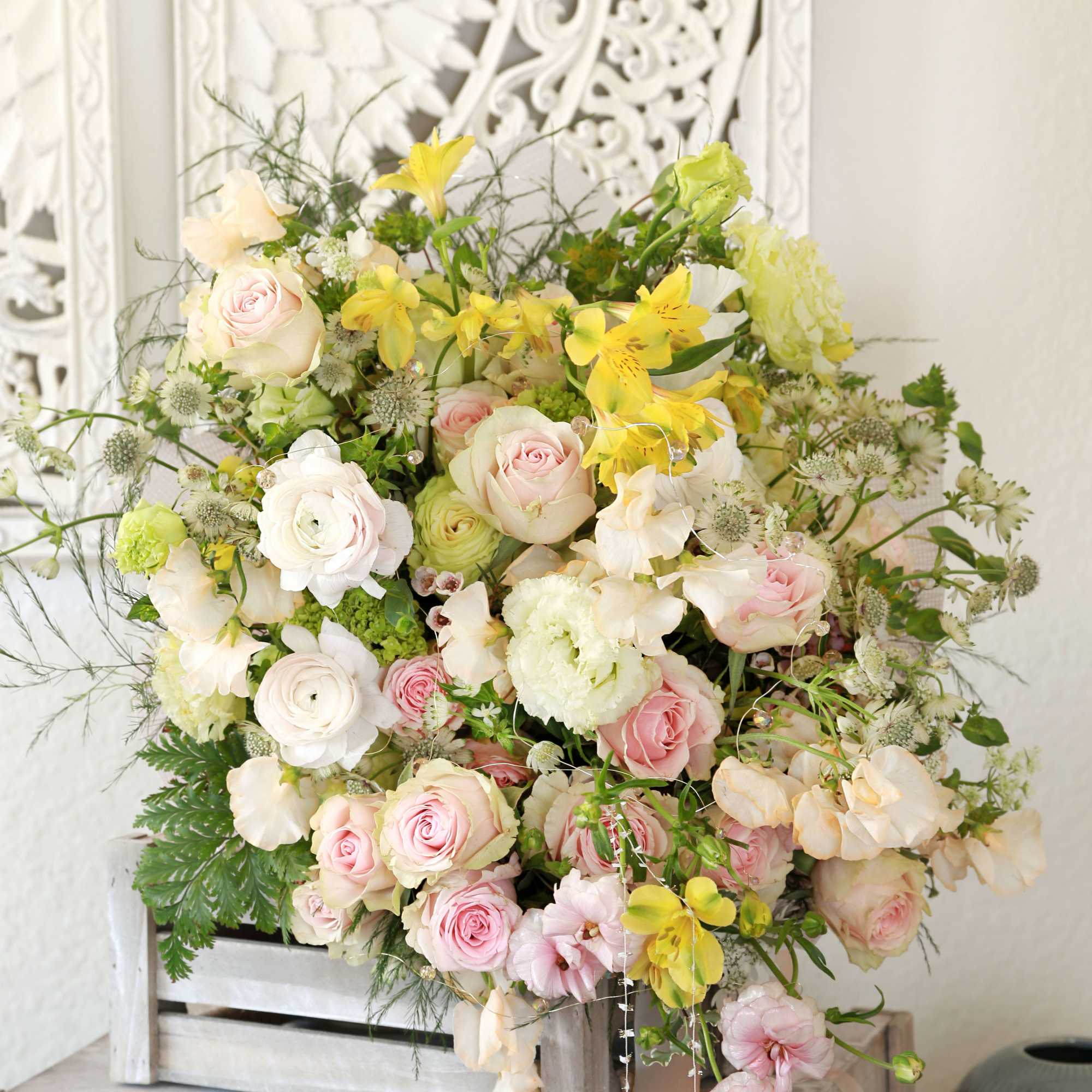 Pic shown as deluxe size. Features Blushes roses, ranunculus, sweet peas with