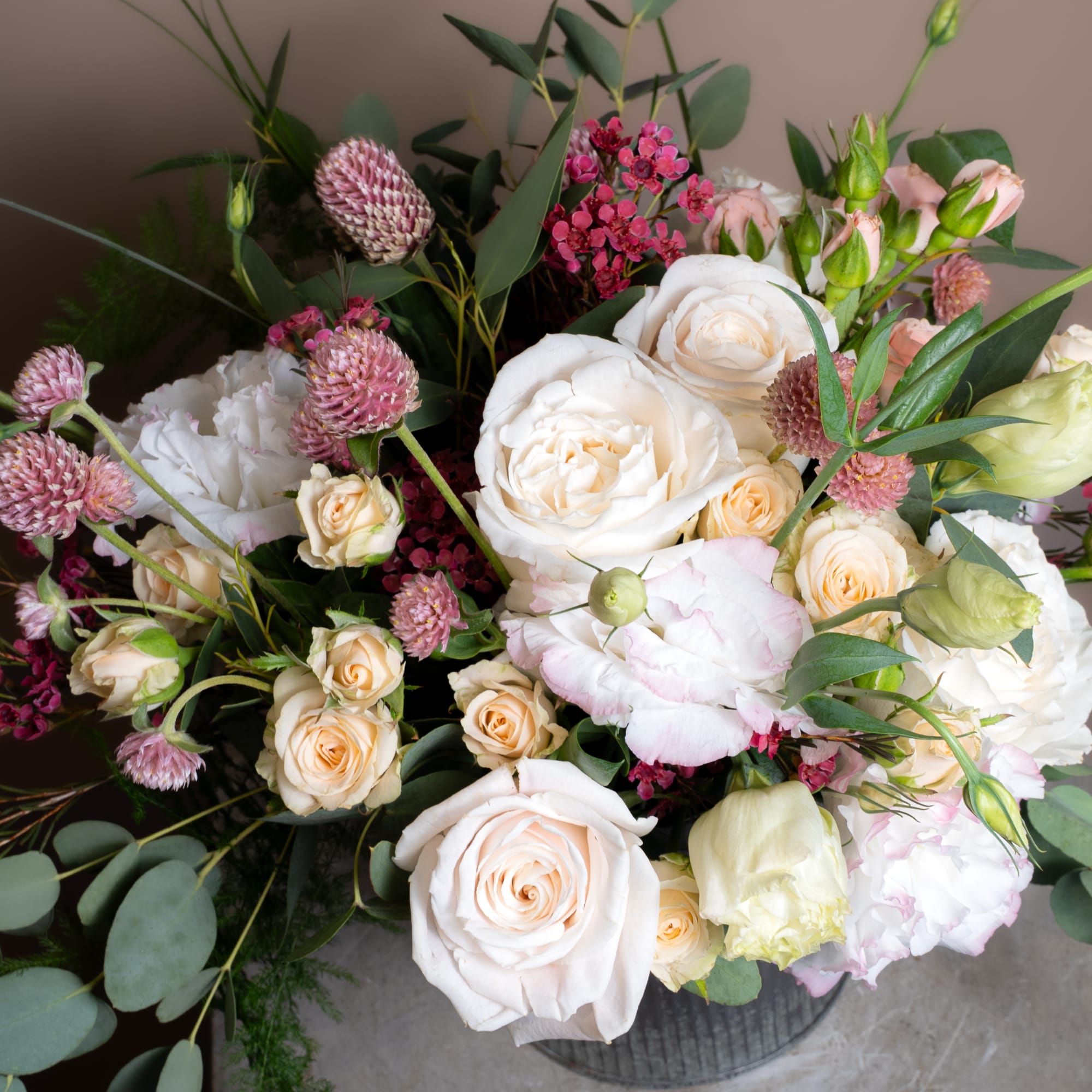Bouquet of white and blush roses with pink accent flowers