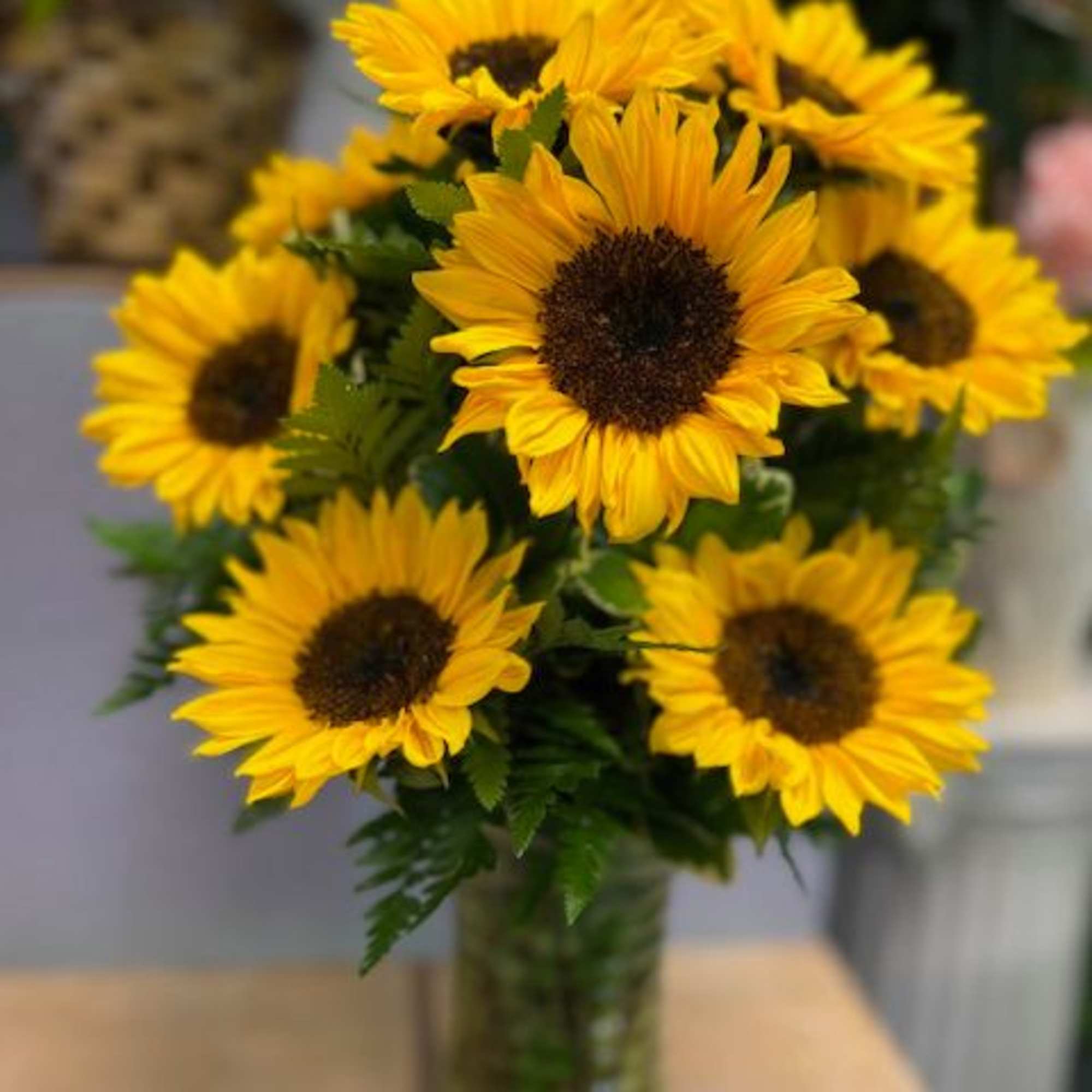 Bouquet of yellow sunflowers in a glass vase