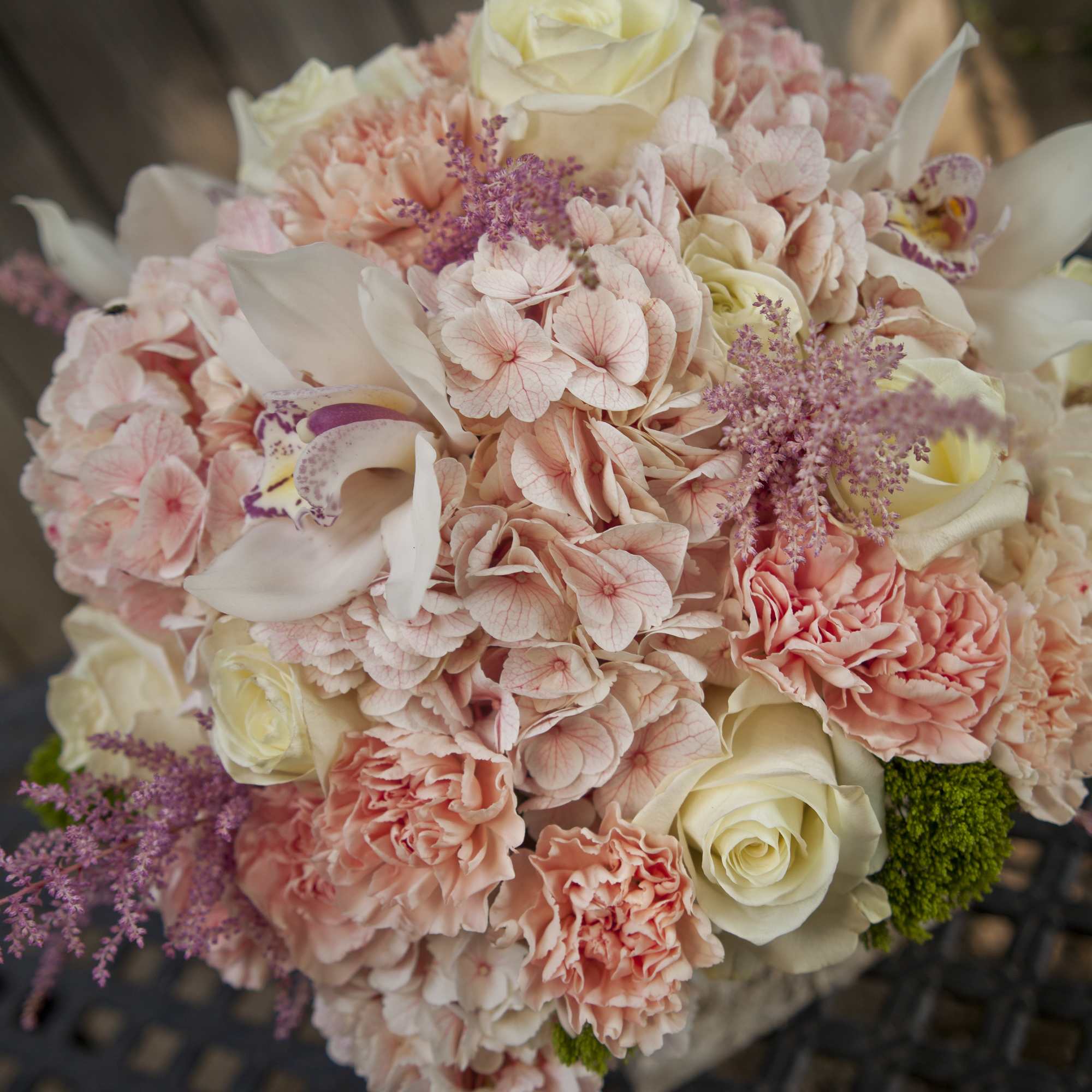 Blush and cream bouquet with roses, hydrangea, orchids, and carnations