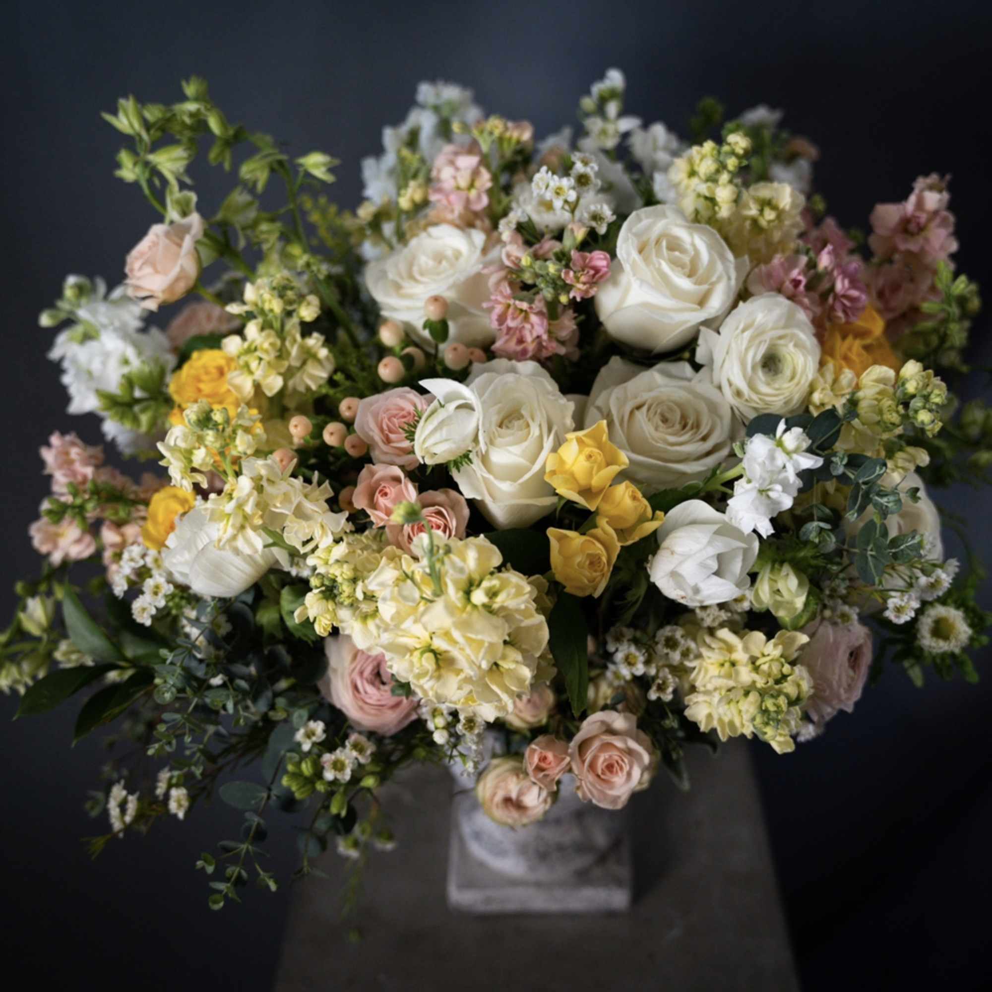 Large bouquet of white, pink, and yellow flowers in a vase