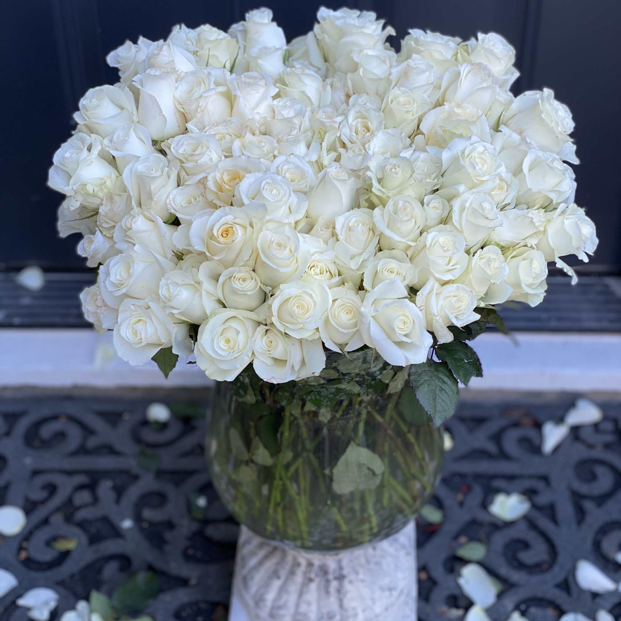 Large bouquet of white roses in a glass vase
