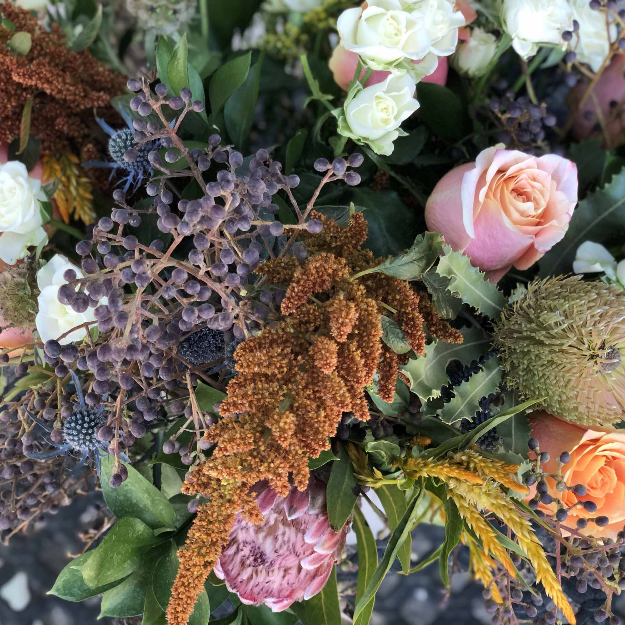 Mixed bouquet with peach and white roses and textured filler flowers