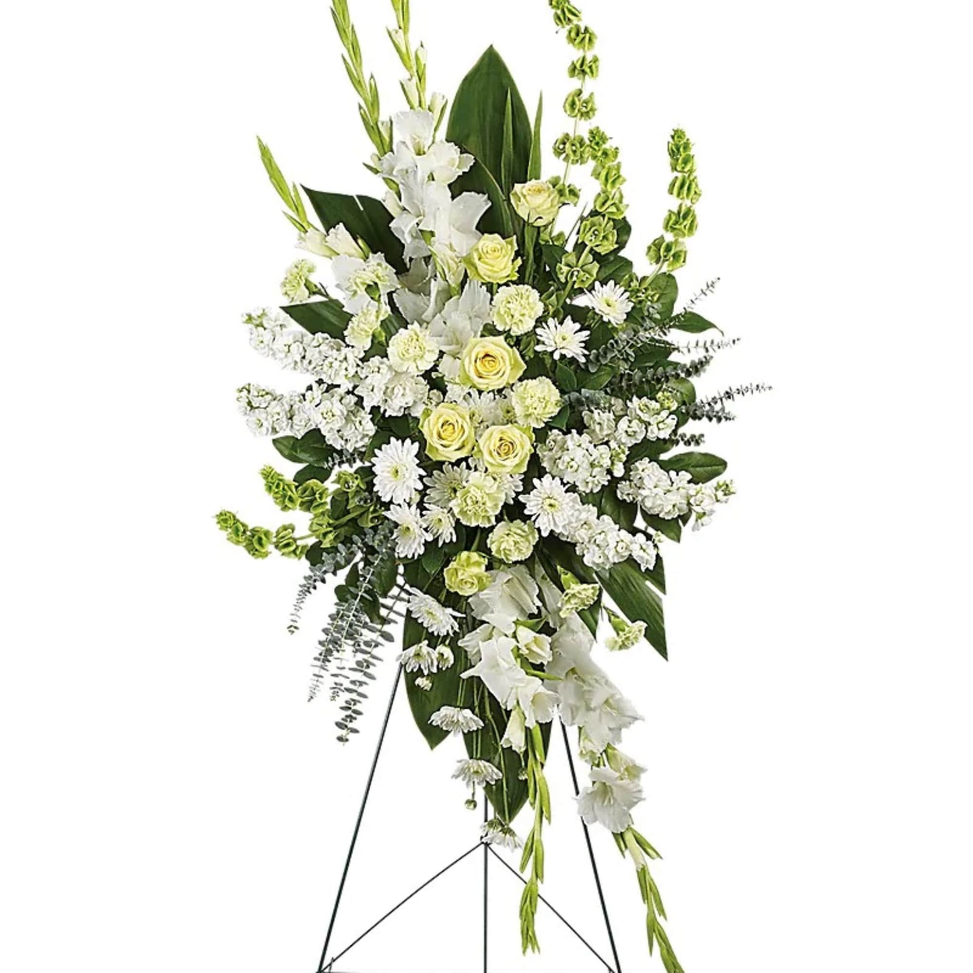 Standing white floral spray with yellow roses on an easel