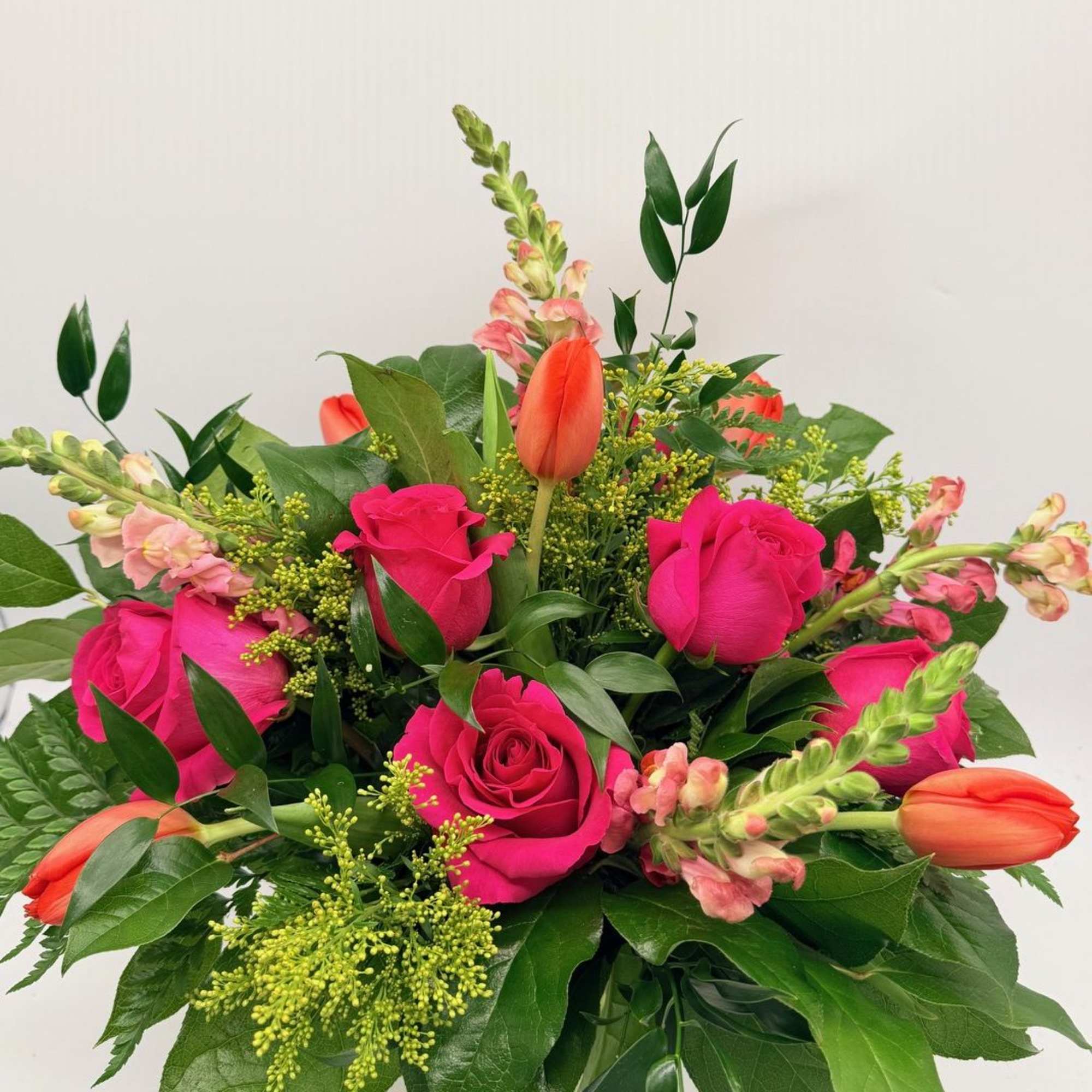 A sweet and stylish mix of roses, tulips, and fresh seasonal blooms.