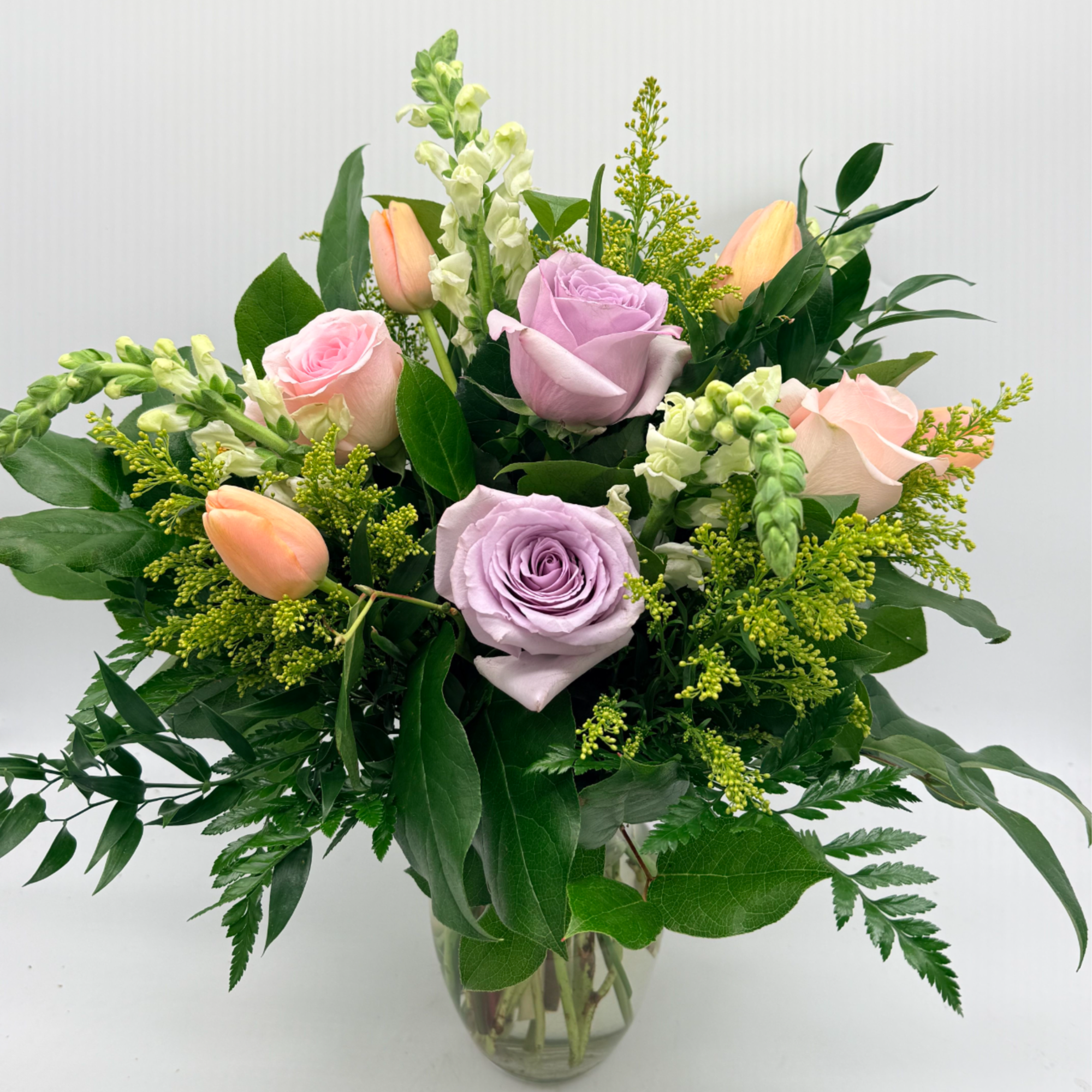 A sweet and stylish mix of roses, tulips, and fresh seasonal blooms.
