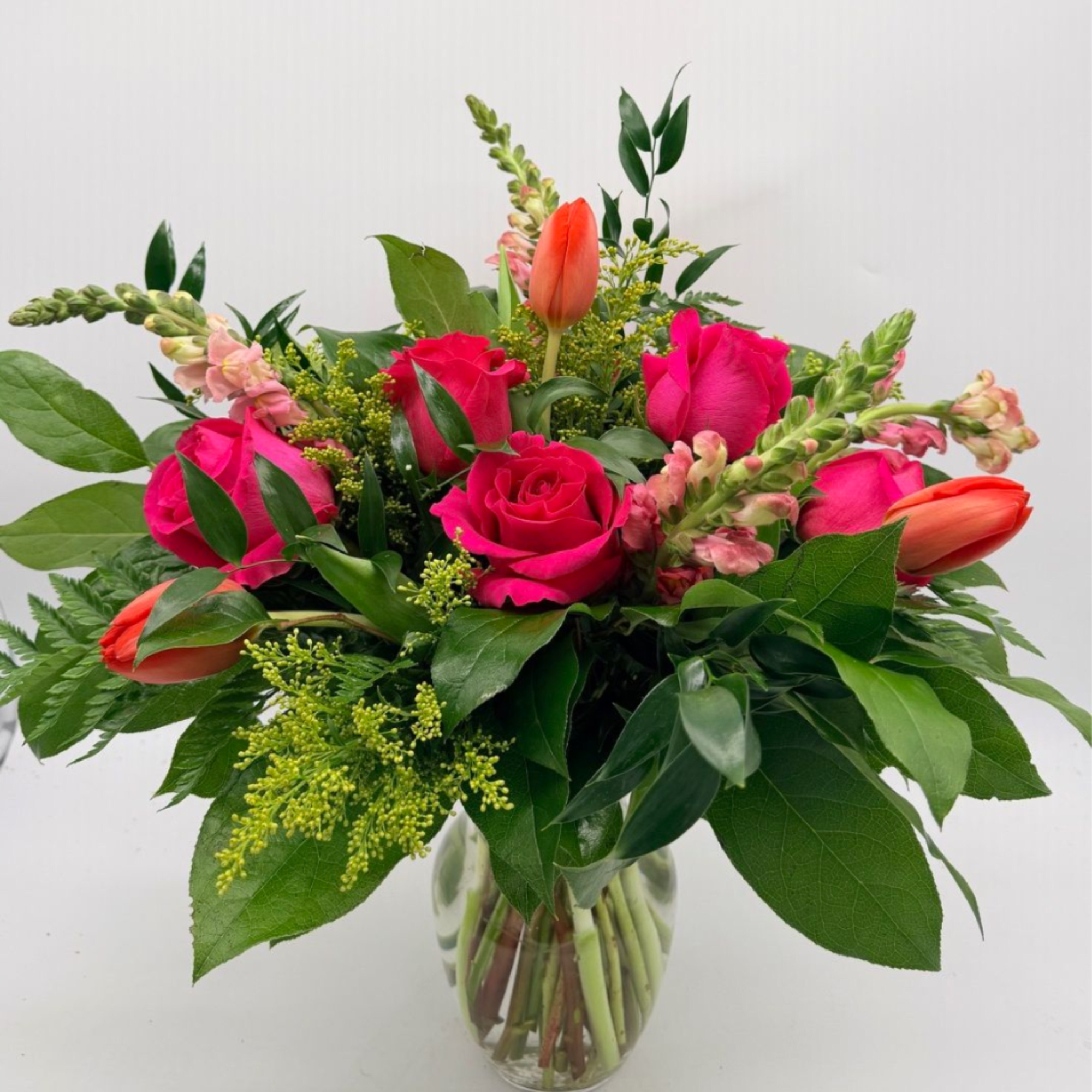 A sweet and stylish mix of roses, tulips, and fresh seasonal blooms.