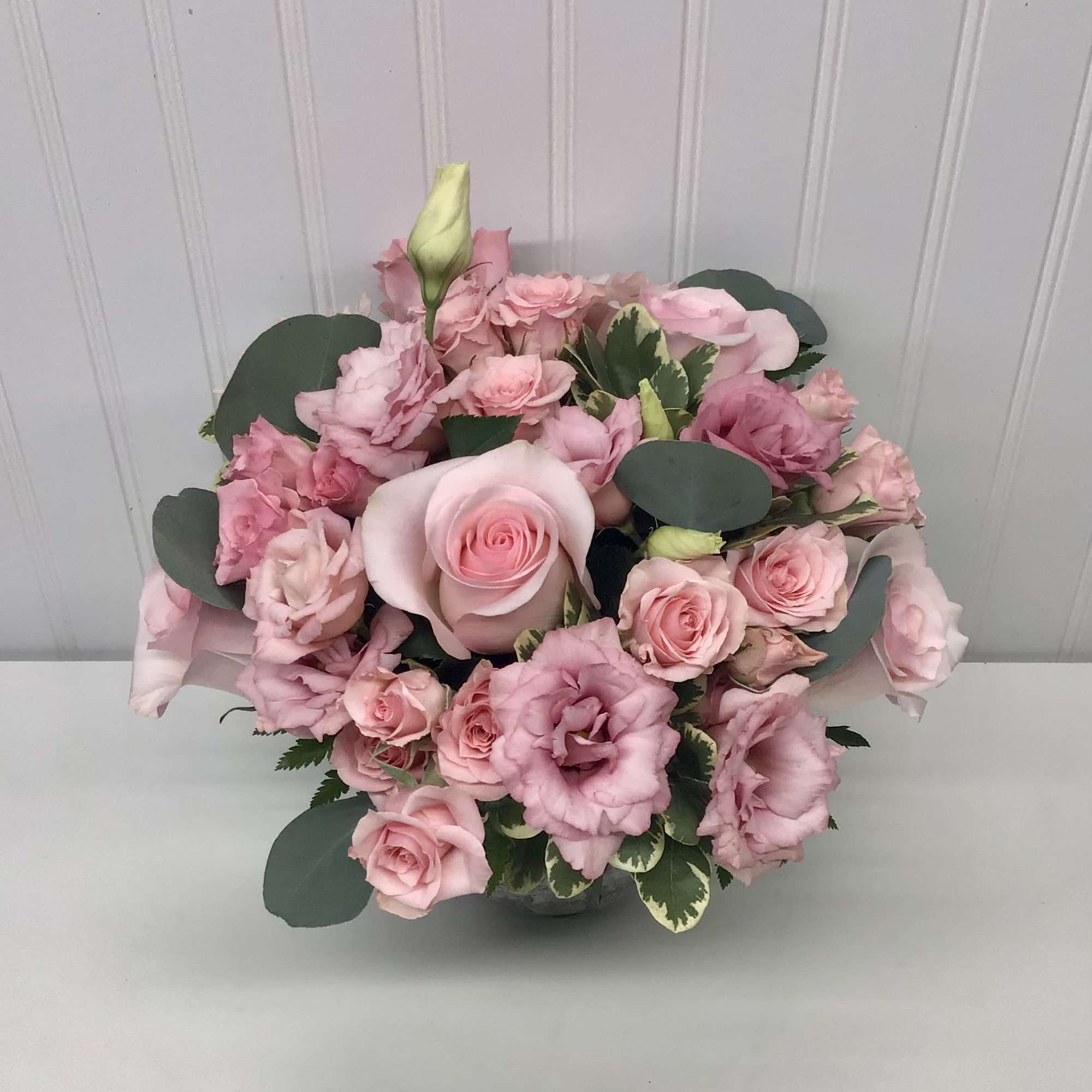 Pink rose bouquet with lisianthus in a low vase