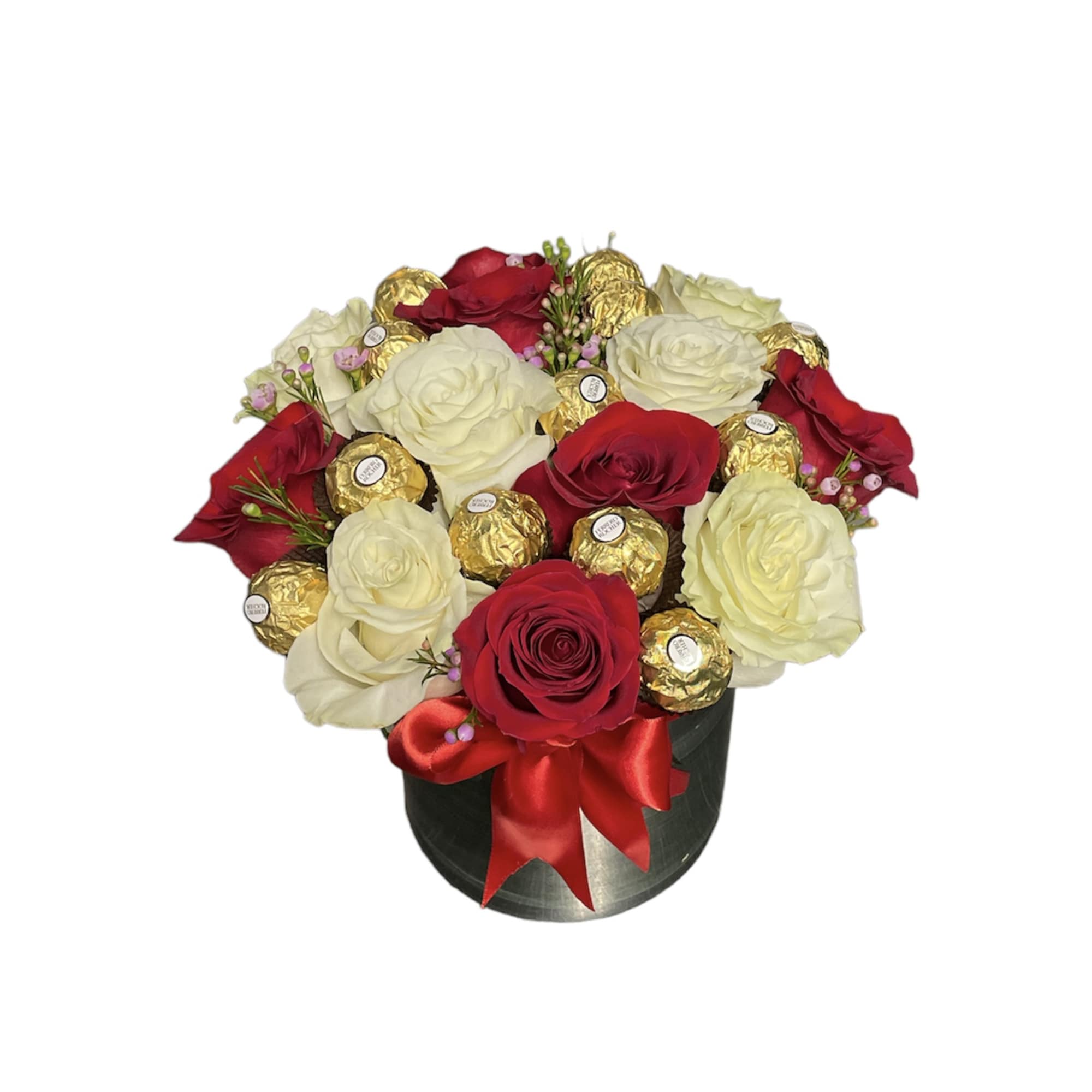 Round box arrangement of red and white roses with gold-wrapped chocolates and red bow