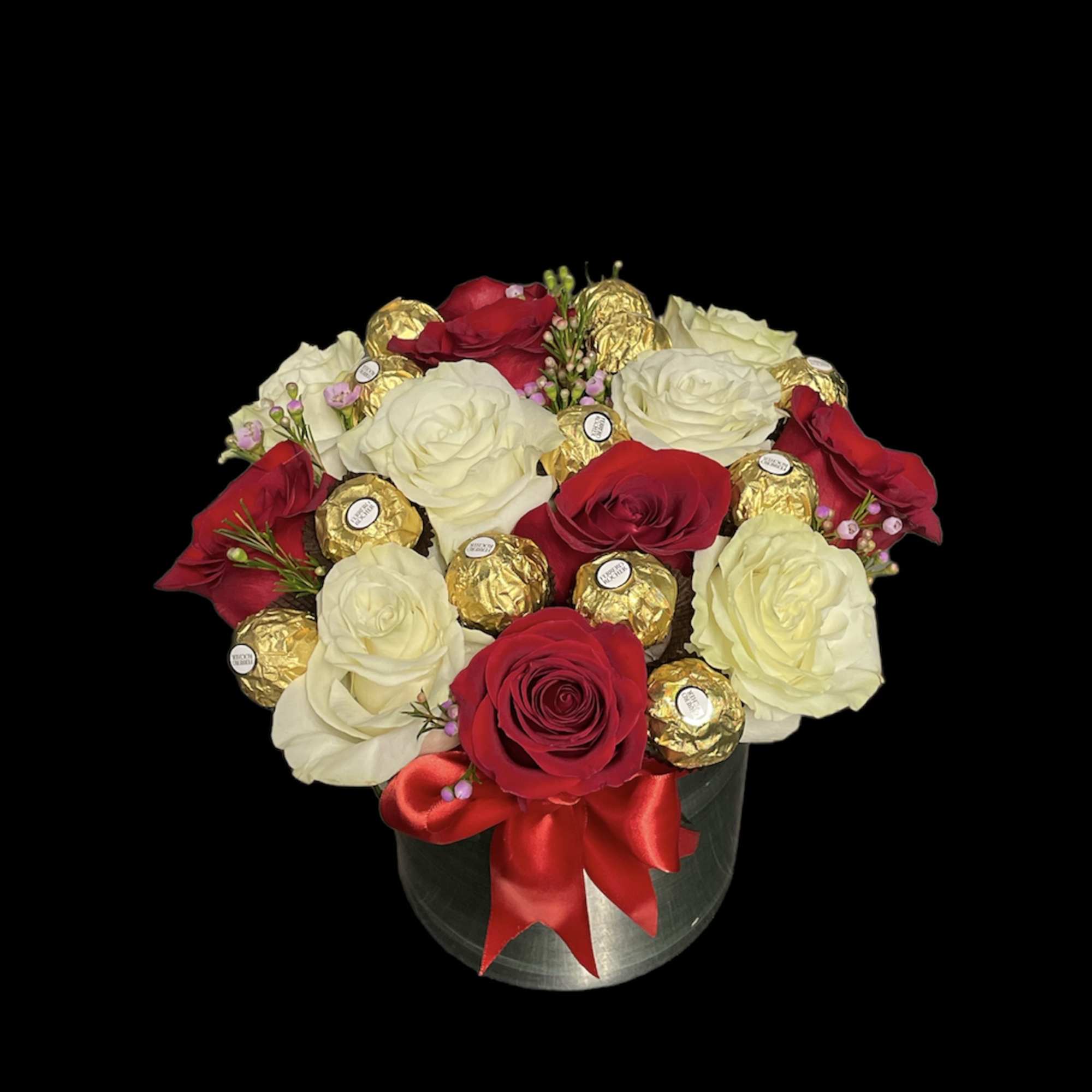 Round arrangement of red and white roses with gold-wrapped chocolates in a silver box with red bow