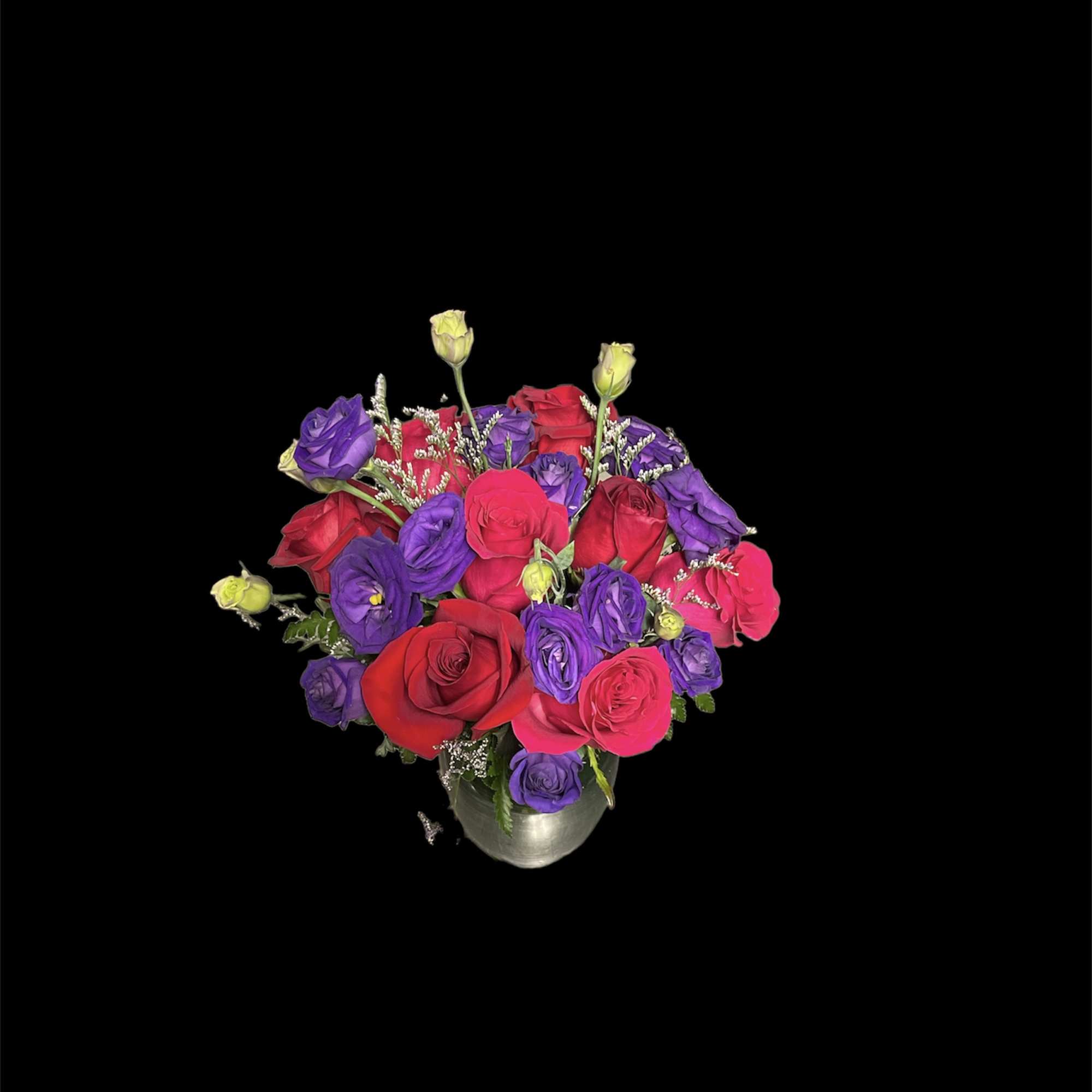 Bouquet of red, pink, and purple roses in a silver vase