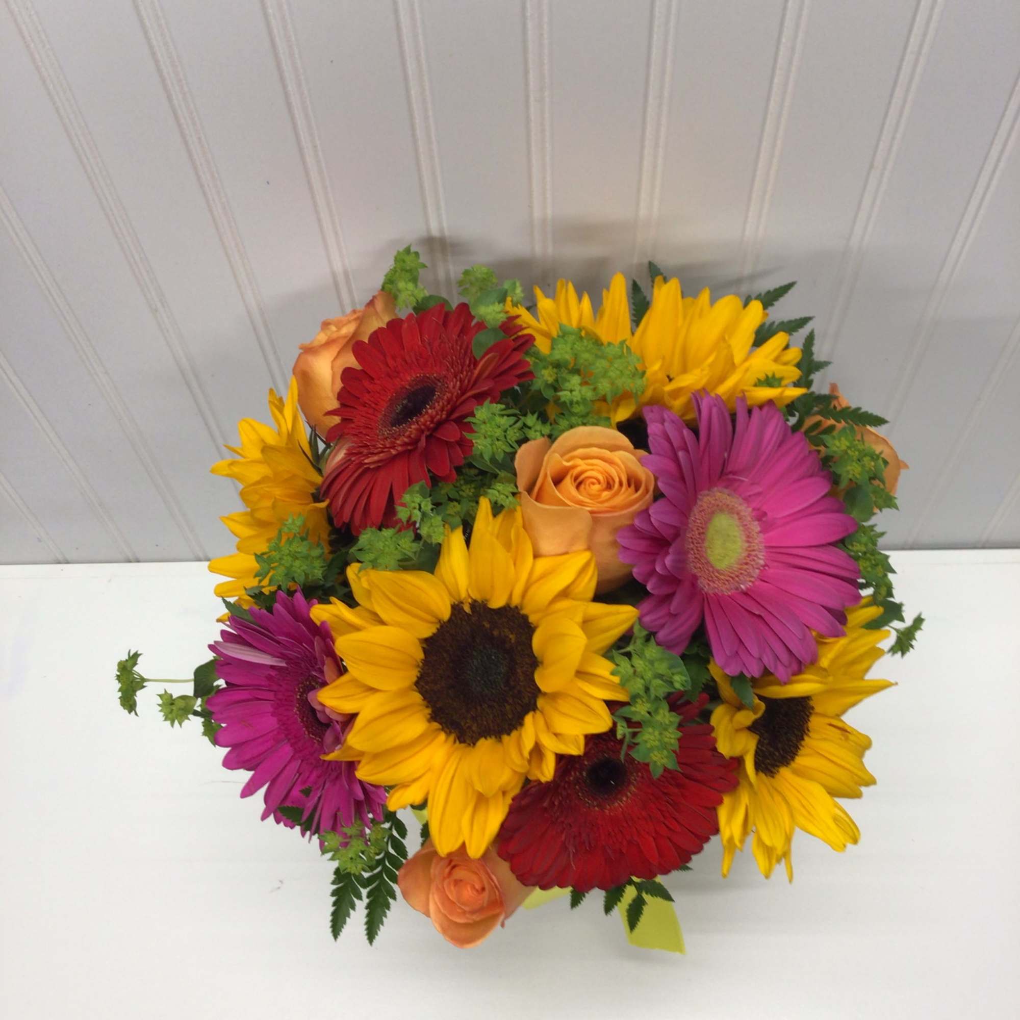Bouquet of sunflowers, gerbera daisies, and orange roses