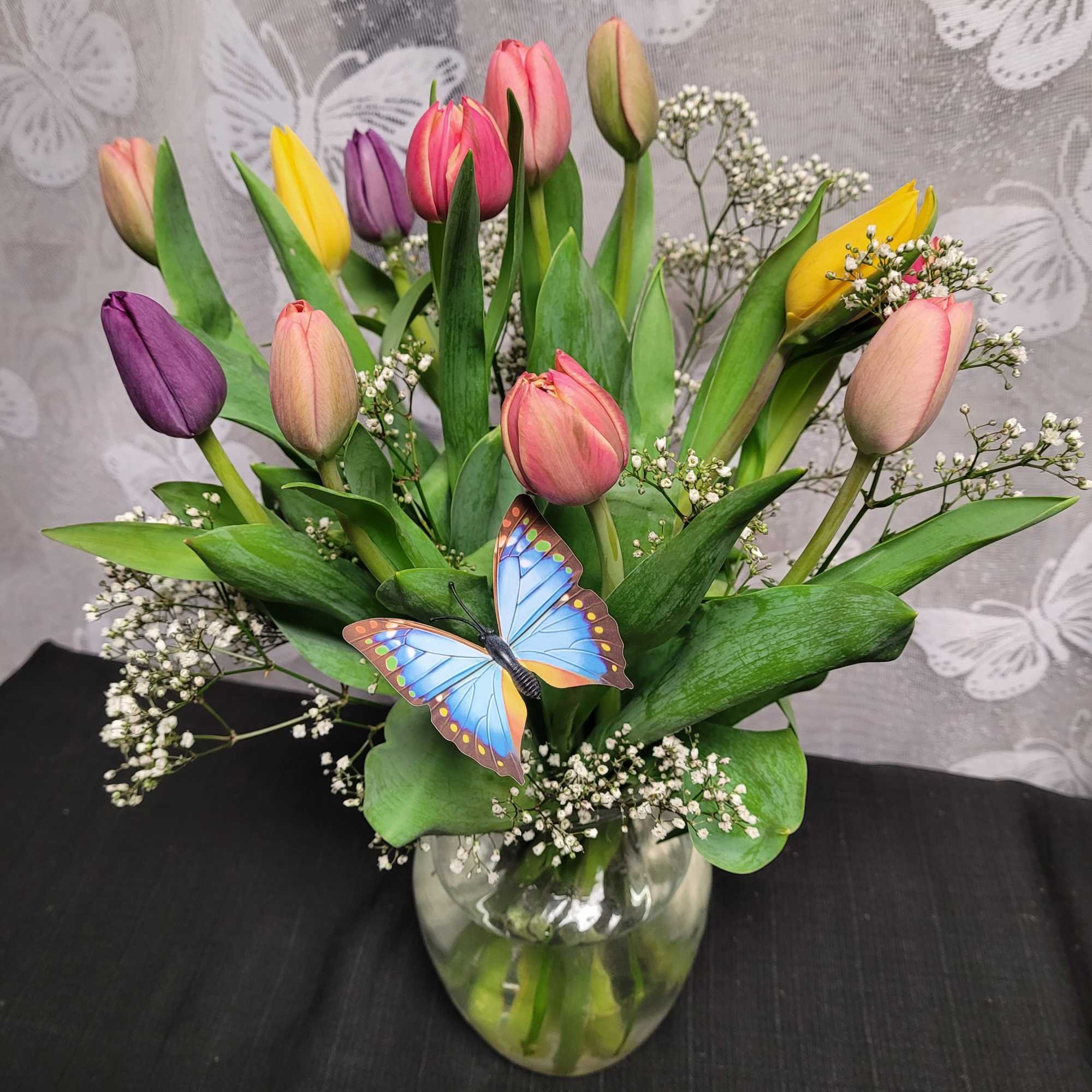 A lively bouquet of mixed-color tulips-rich purples, bright reds, soft pinks, sunny
