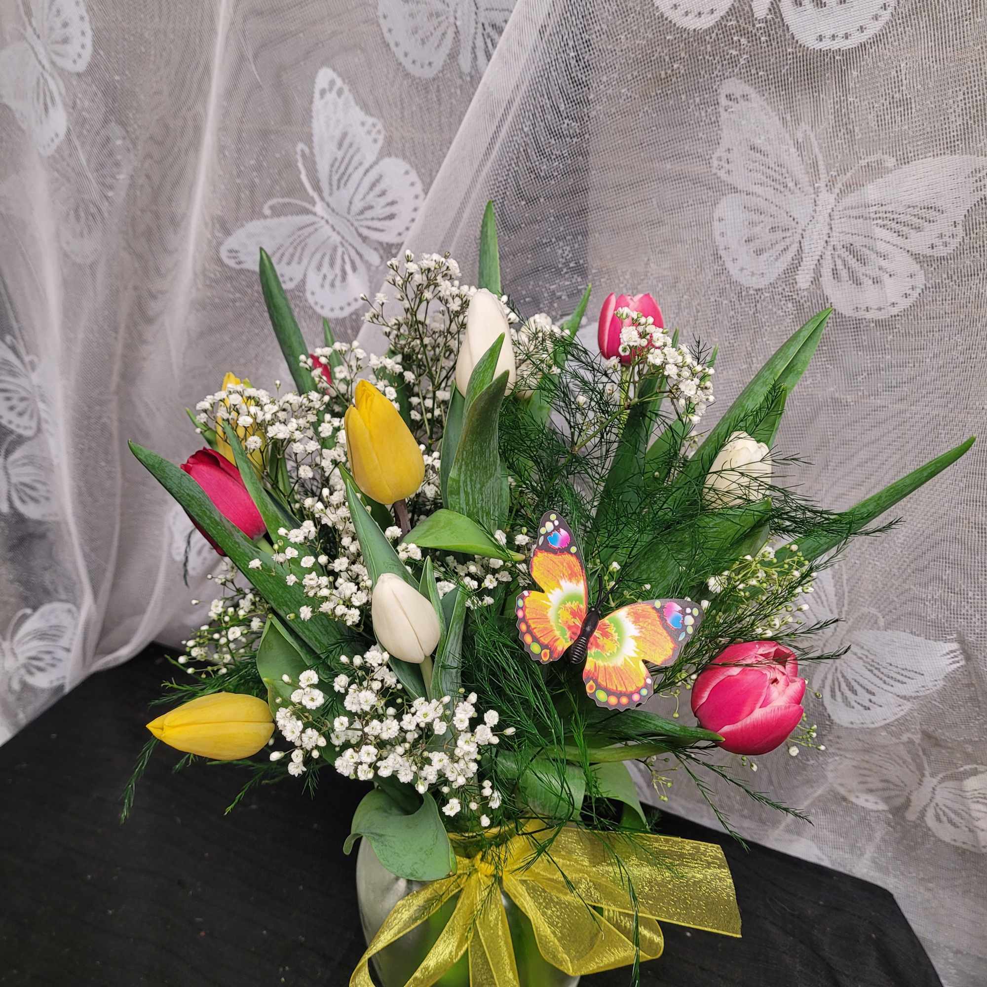 A lively bouquet of mixed-color tulips-rich purples, bright reds, soft pinks, sunny