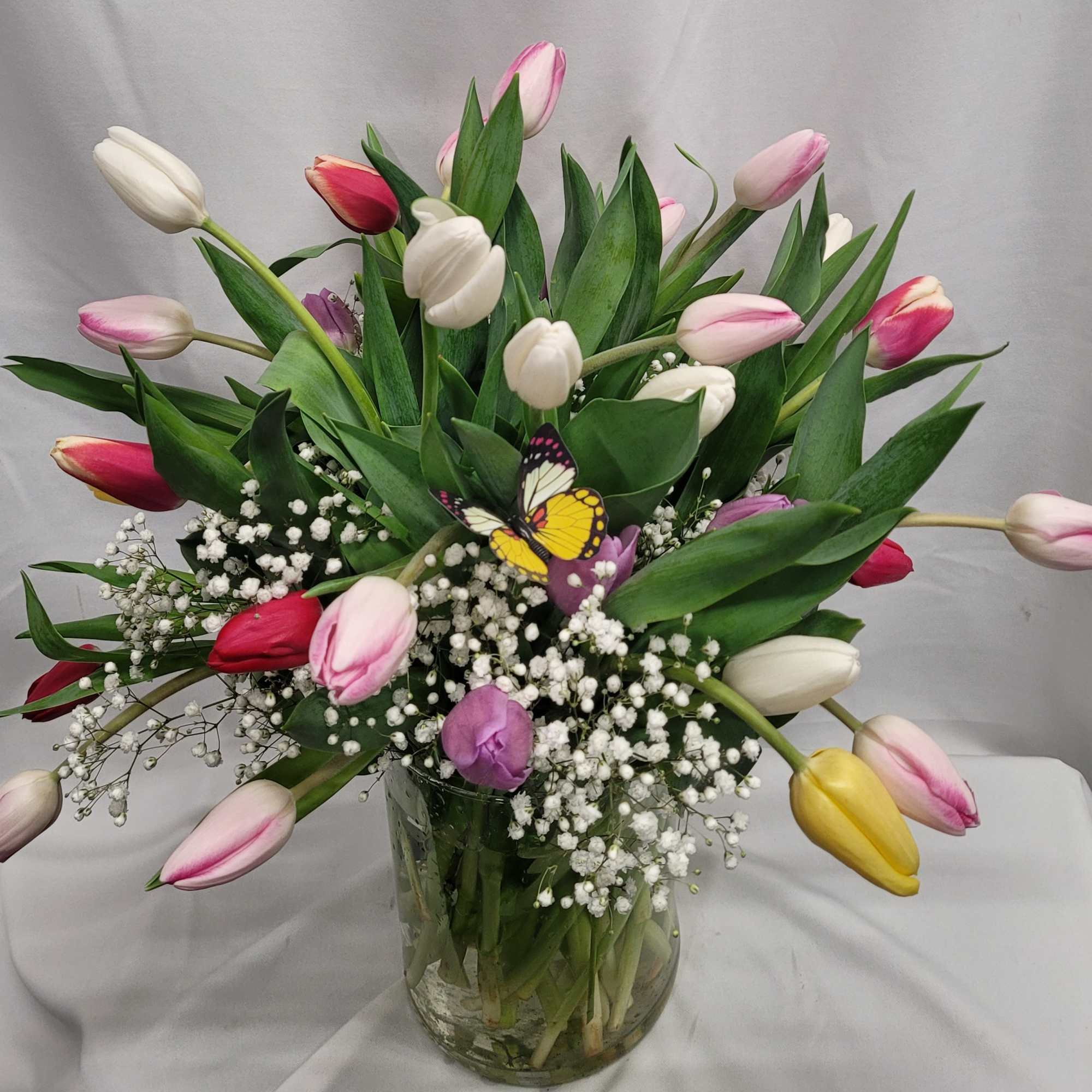 A lively bouquet of mixed-color tulips-rich purples, bright reds, soft pinks, sunny