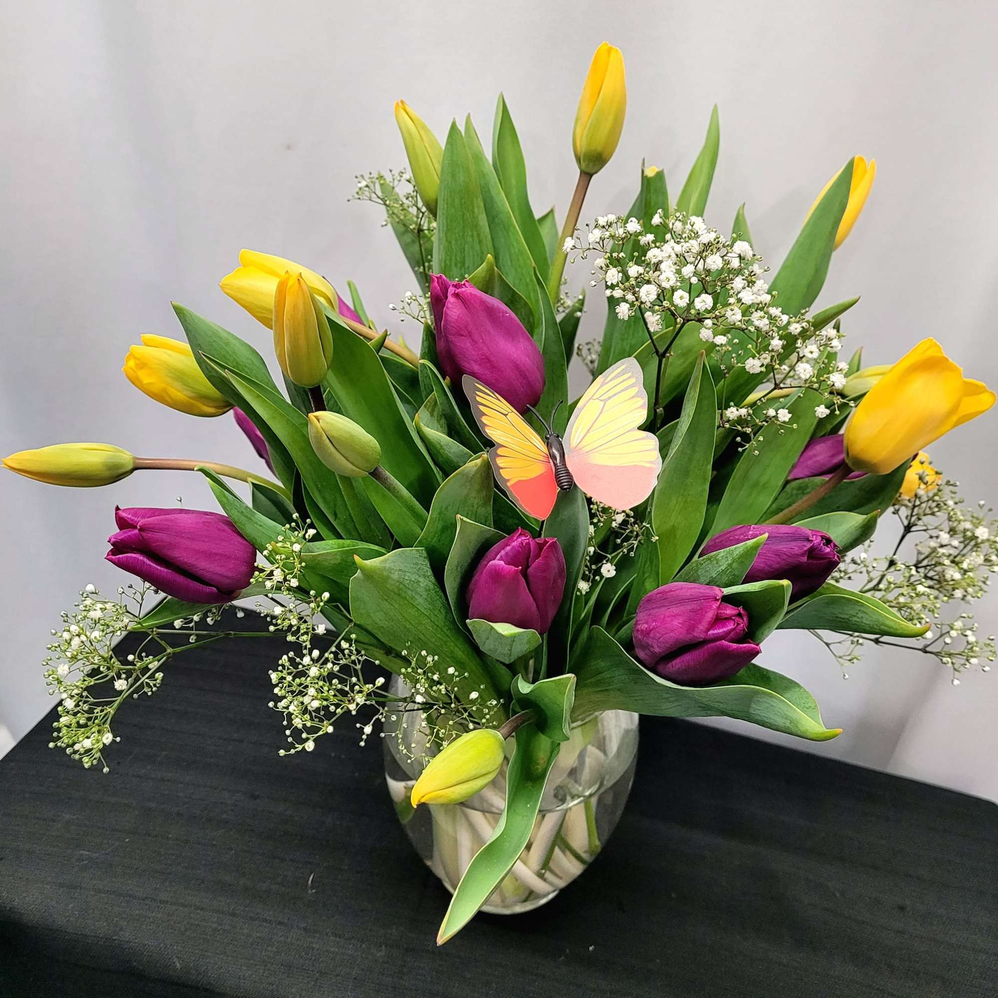 A lively bouquet of mixed-color tulips-rich purples, bright reds, soft pinks, sunny
