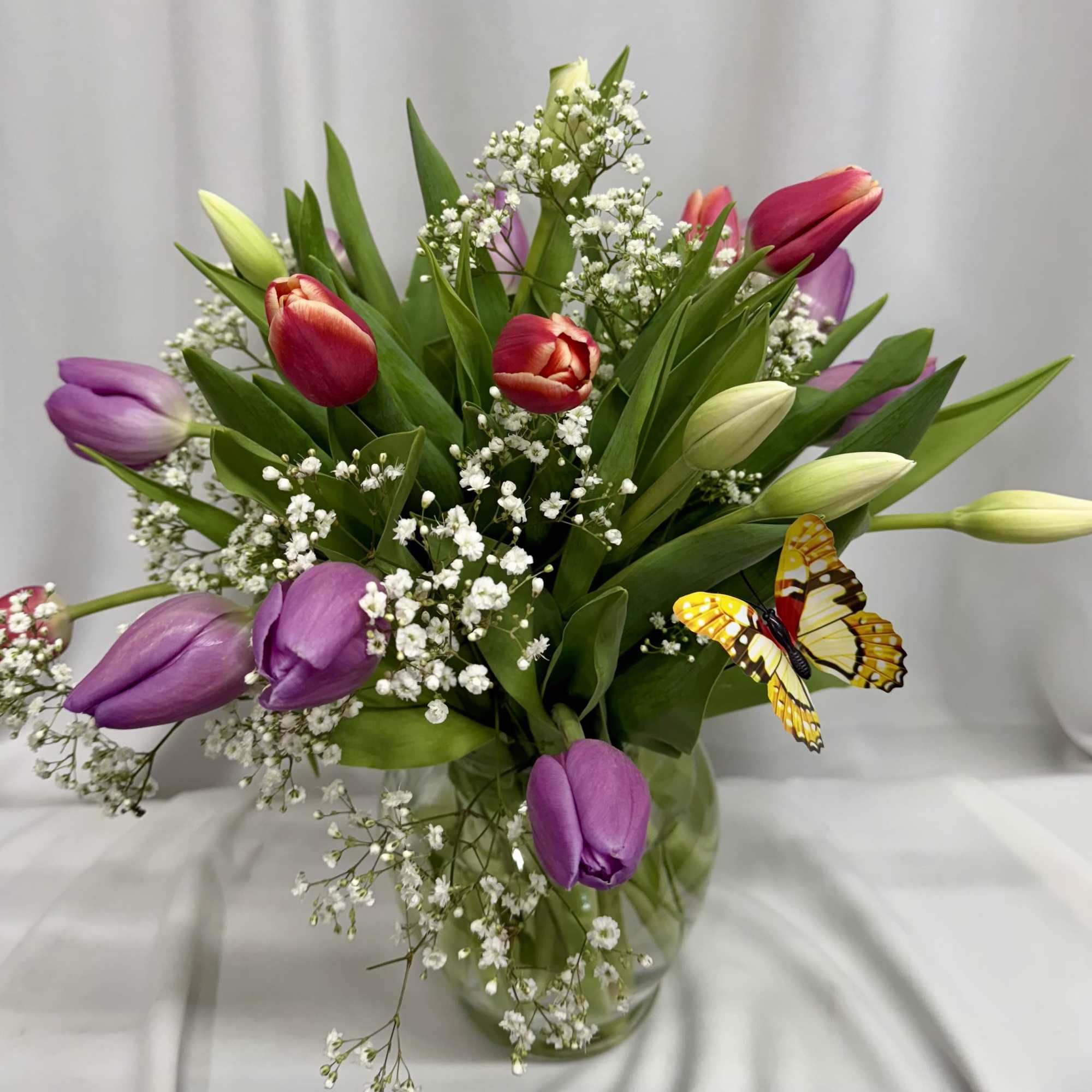 A lively bouquet of mixed-color tulips-rich purples, bright reds, soft pinks, sunny