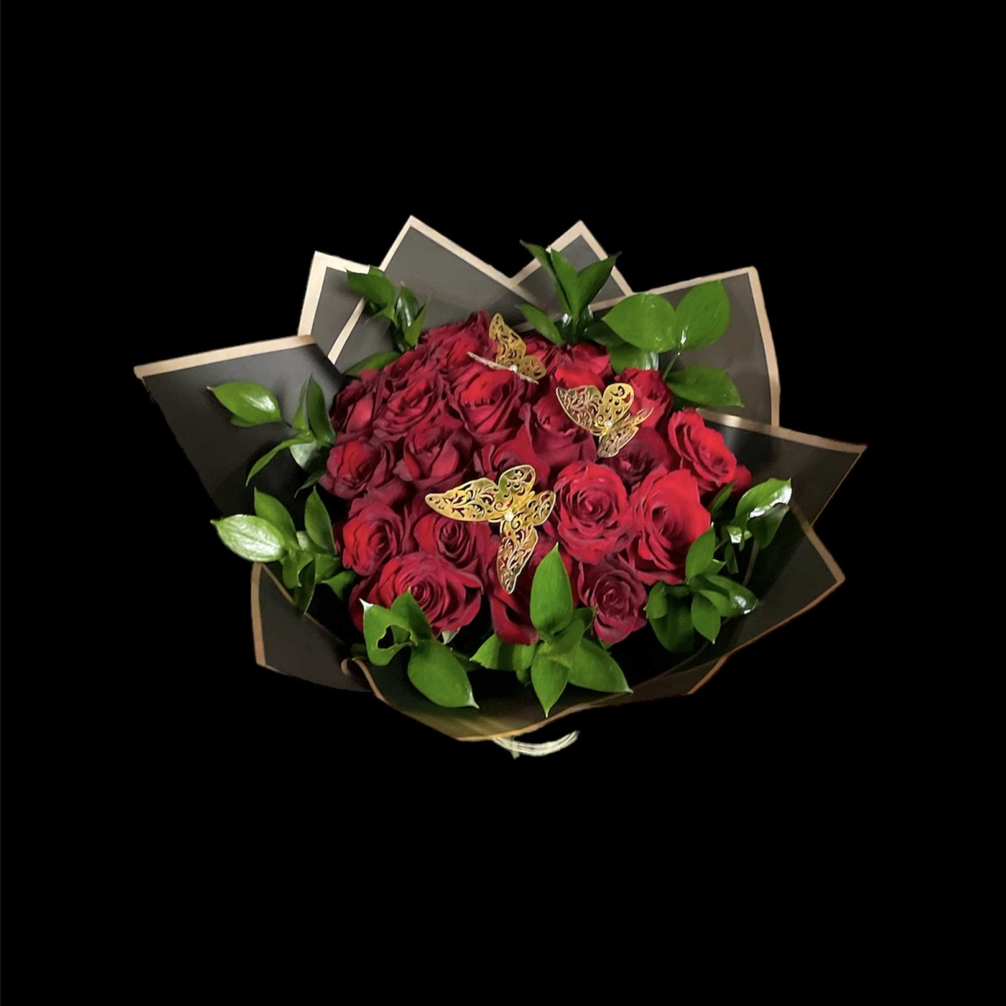 Bouquet of red roses with green foliage and butterfly accents