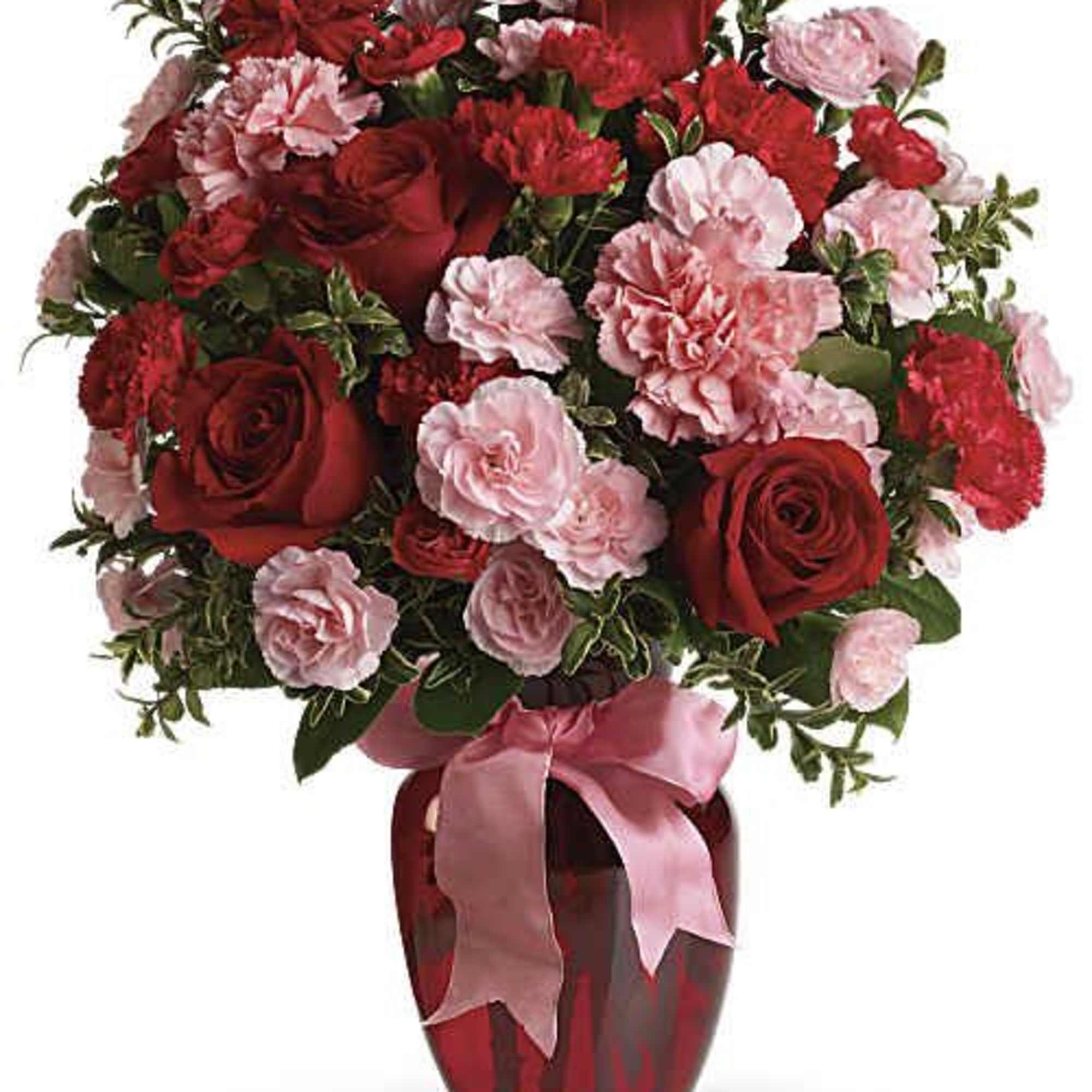 Red roses and pink carnations in a red vase with a pink ribbon