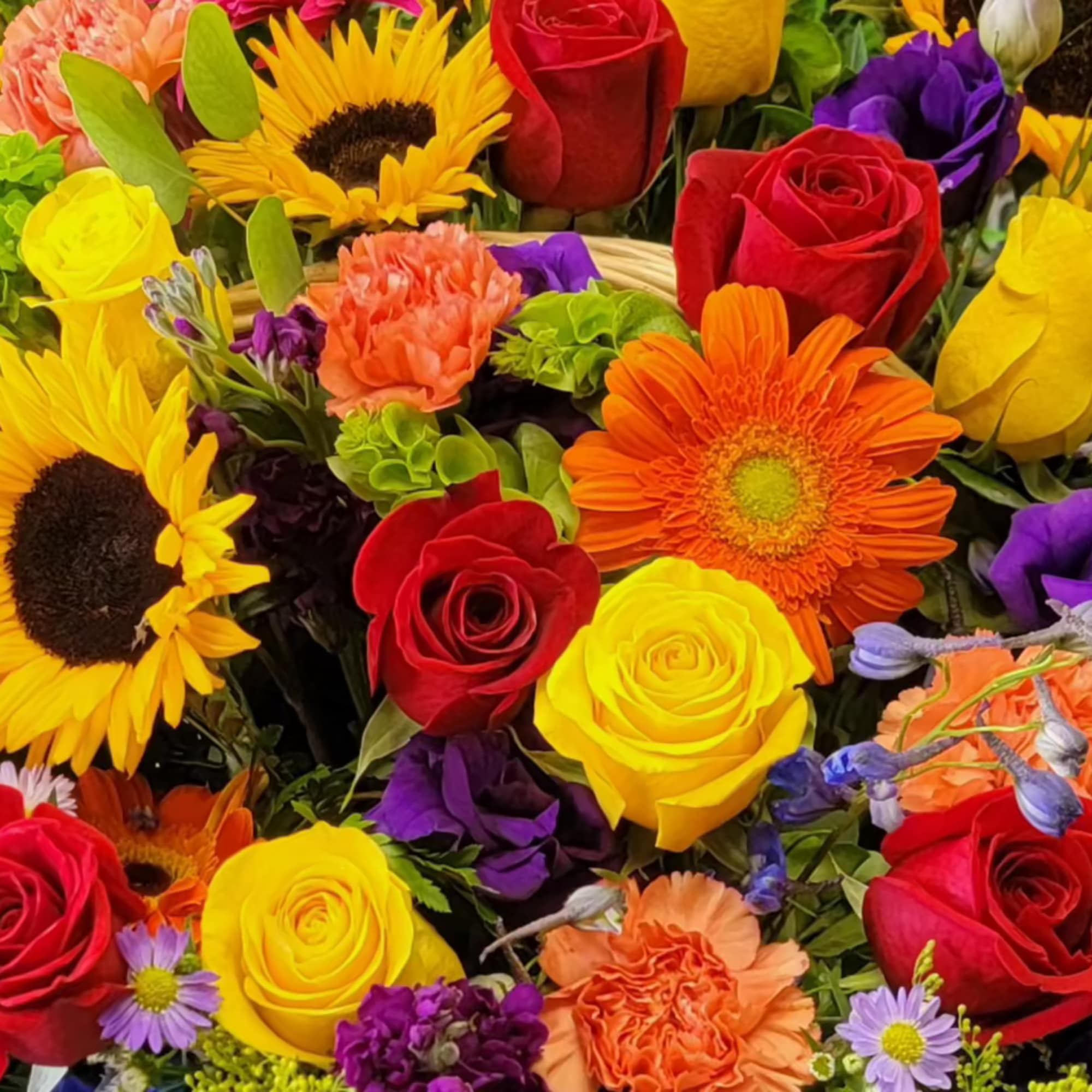 Mixed bouquet of red and yellow roses with sunflowers and orange gerbera daisies