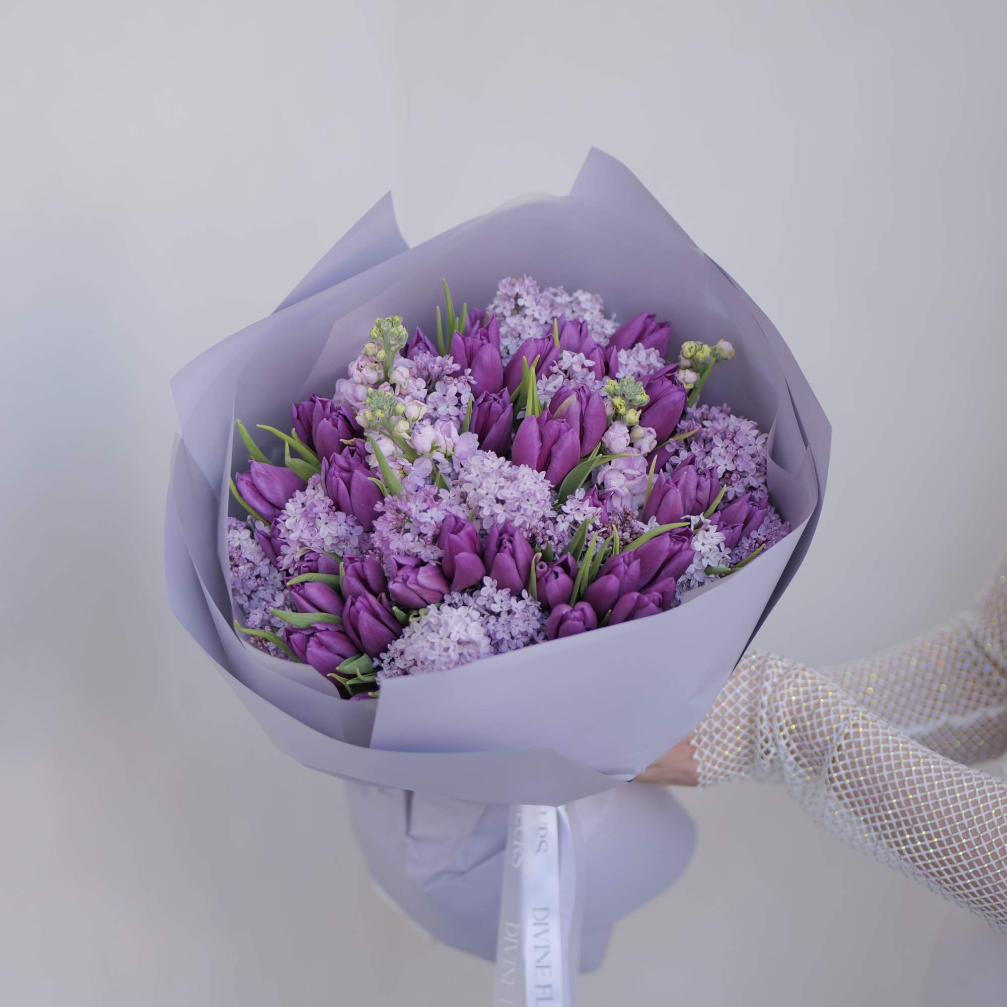 A beautifully handcrafted floral arrangement featuring delicate lilac blooms, thoughtfully designed to
