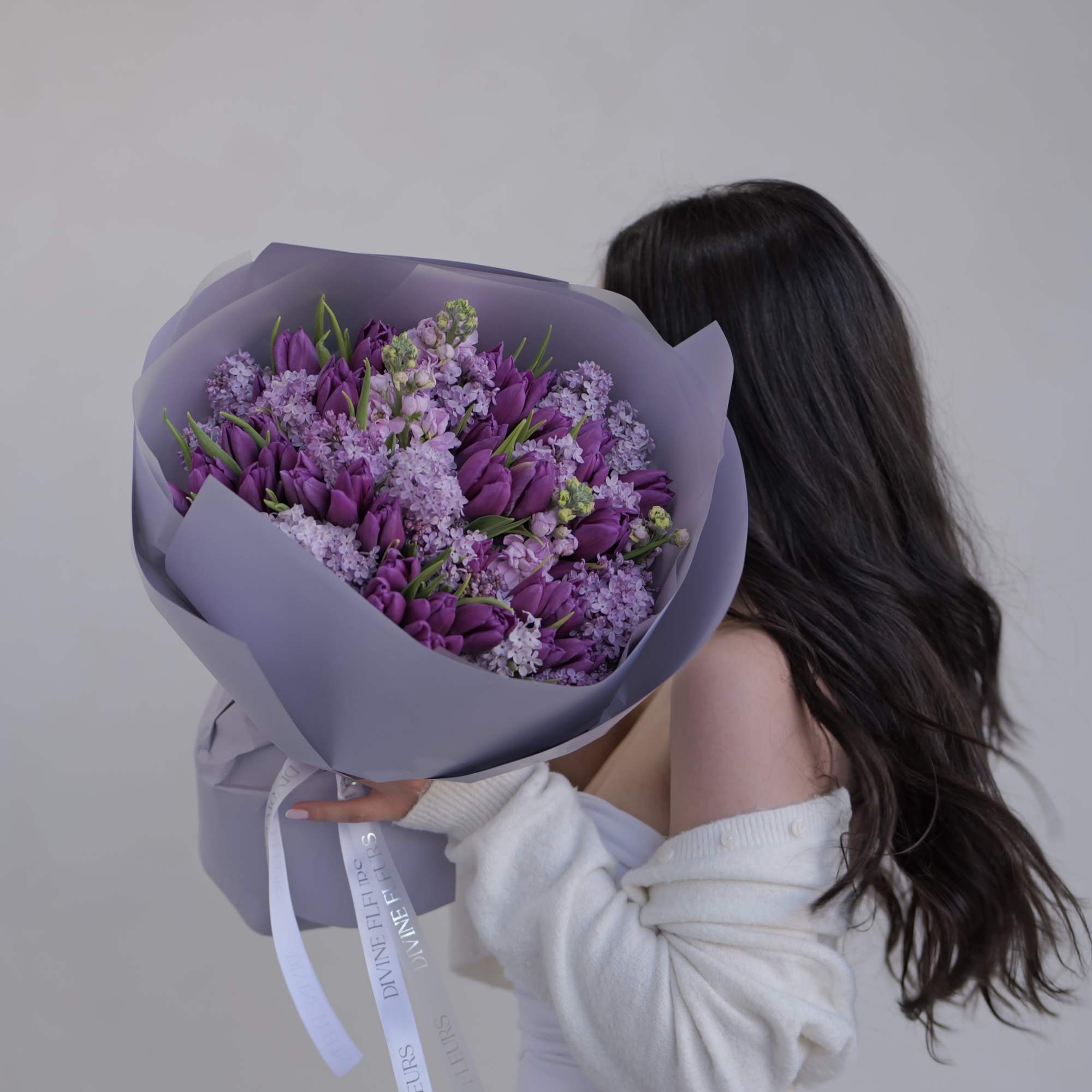 A beautifully handcrafted floral arrangement featuring delicate lilac blooms, thoughtfully designed to