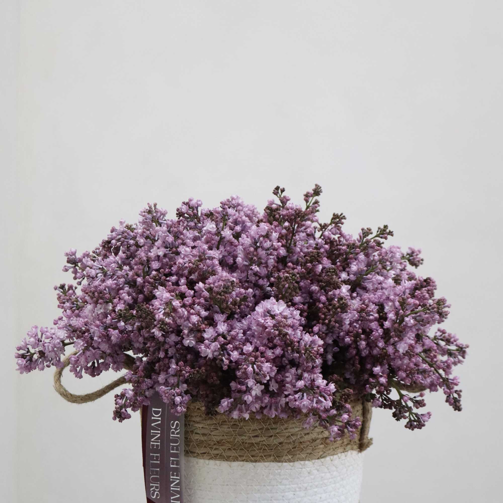 A beautifully handcrafted floral arrangement featuring delicate lilac blooms, thoughtfully designed to