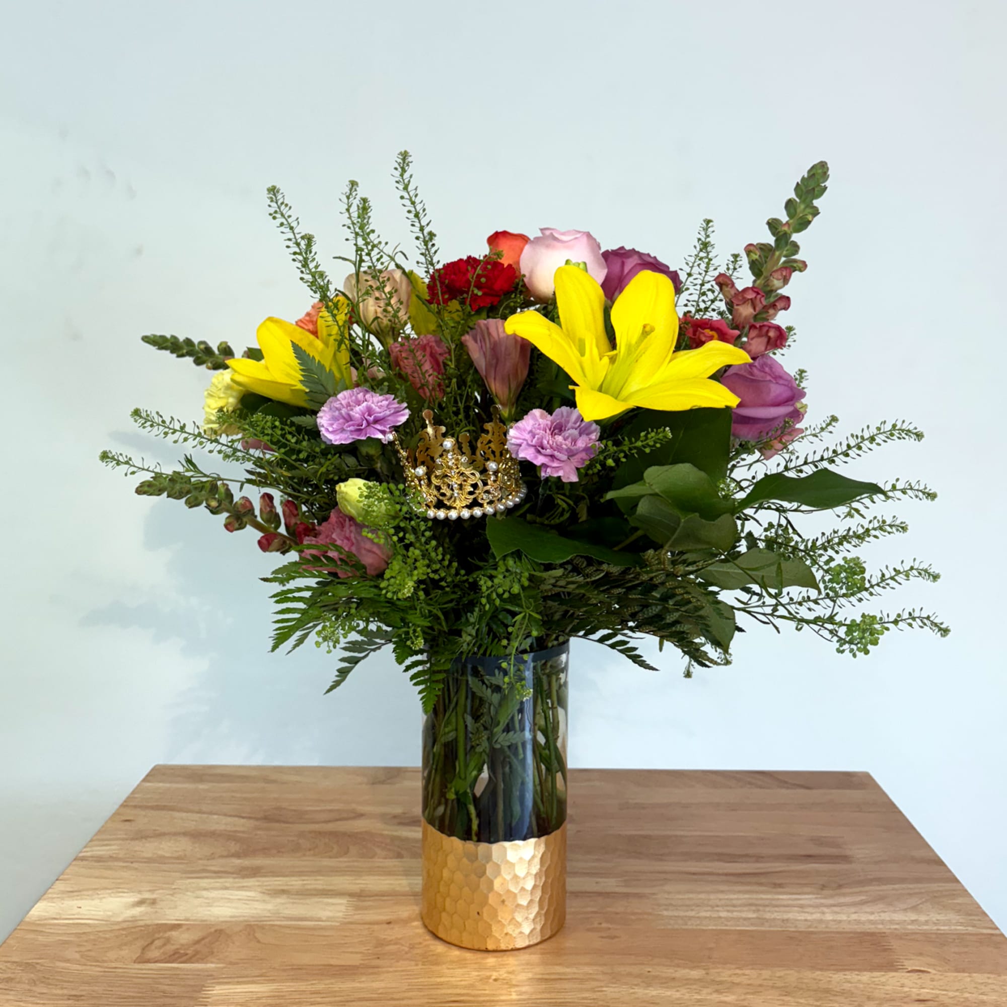 An elegant holiday arrangement showcasing a vibrant multicolored palette. Featuring flowers such