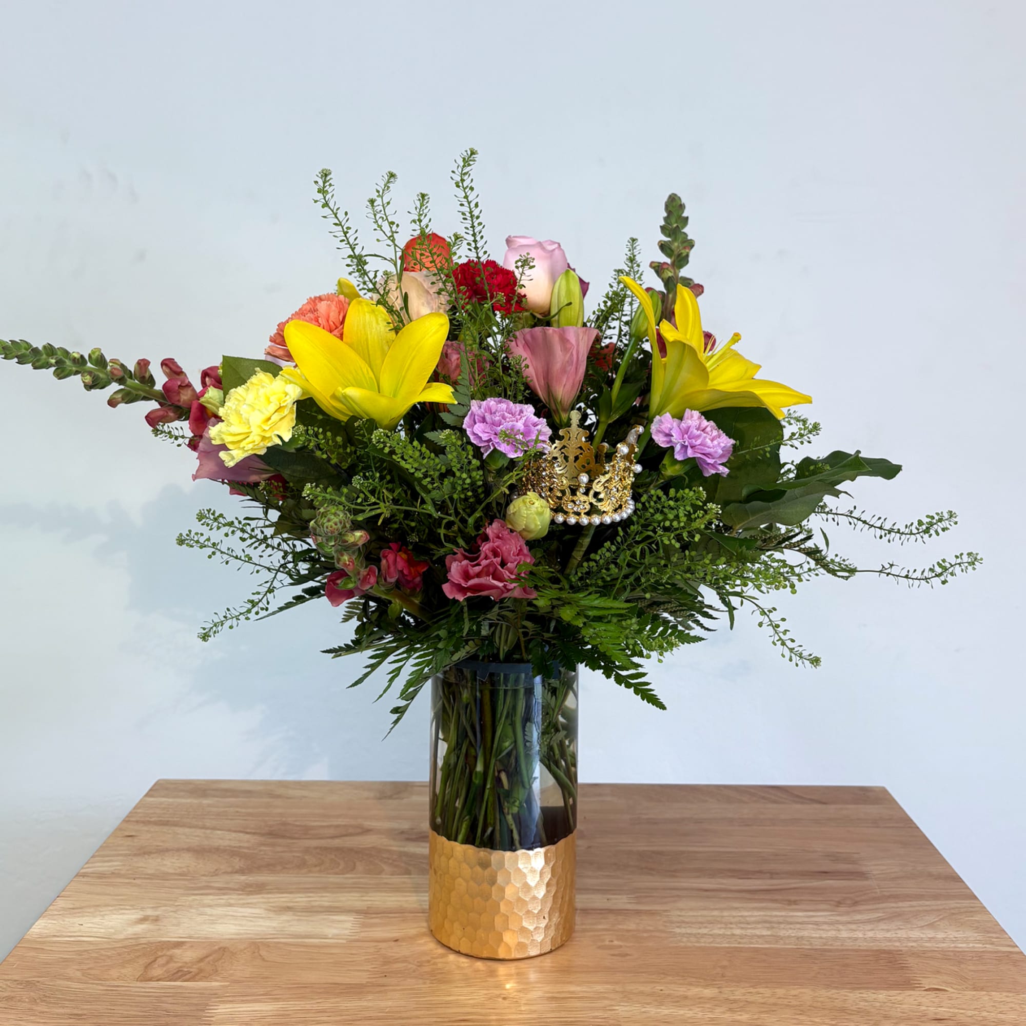 An elegant holiday arrangement showcasing a vibrant multicolored palette. Featuring flowers such